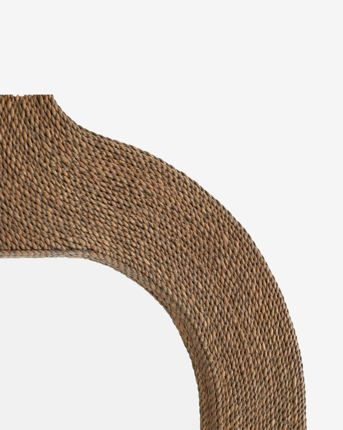 Close-up of the Elysia Mirror’s corner, featuring a textured woven rattan or abaca rope frame inspired by Indian architecture, set against a white background by McGee & Co.