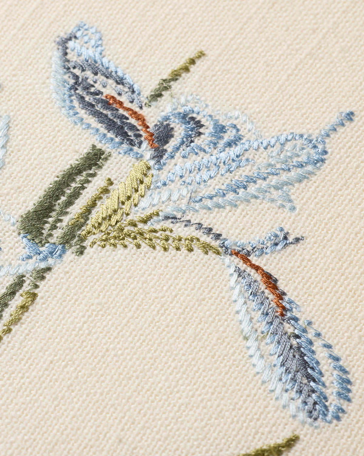 Close-up of the Embroidered Blue Iris, showcasing cotton embroidery in green and brown on beige fabric—perfect as botanical wall art, by McGee & Co.