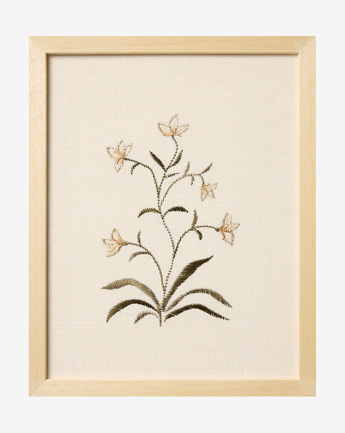 Embroidered Pixie Flowers features five beige embroidered flowers with green leaves on cream fabric, framed in light wood for a charming botanical wall art accent, by McGee & Co.