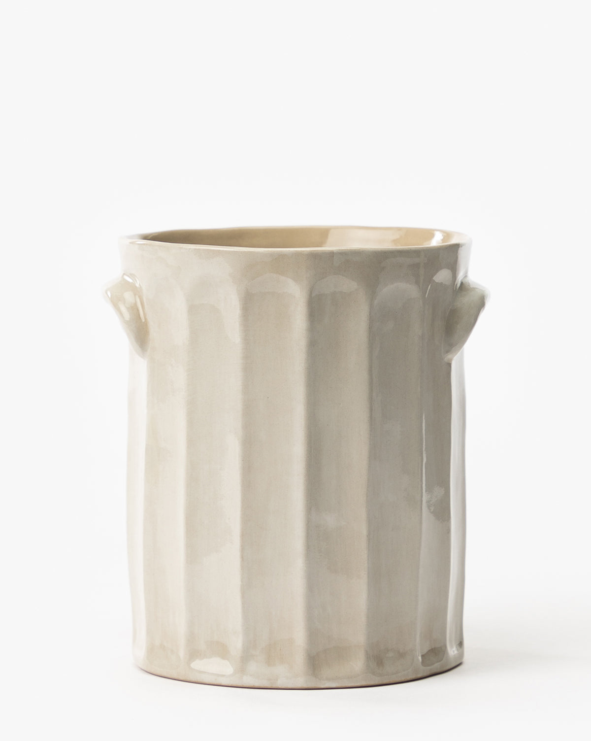 The Emilia Crock is a beige ceramic vase with a glossy finish, vertical ridges, and two small side handles—perfect for displaying on your kitchen countertop against a plain white background.