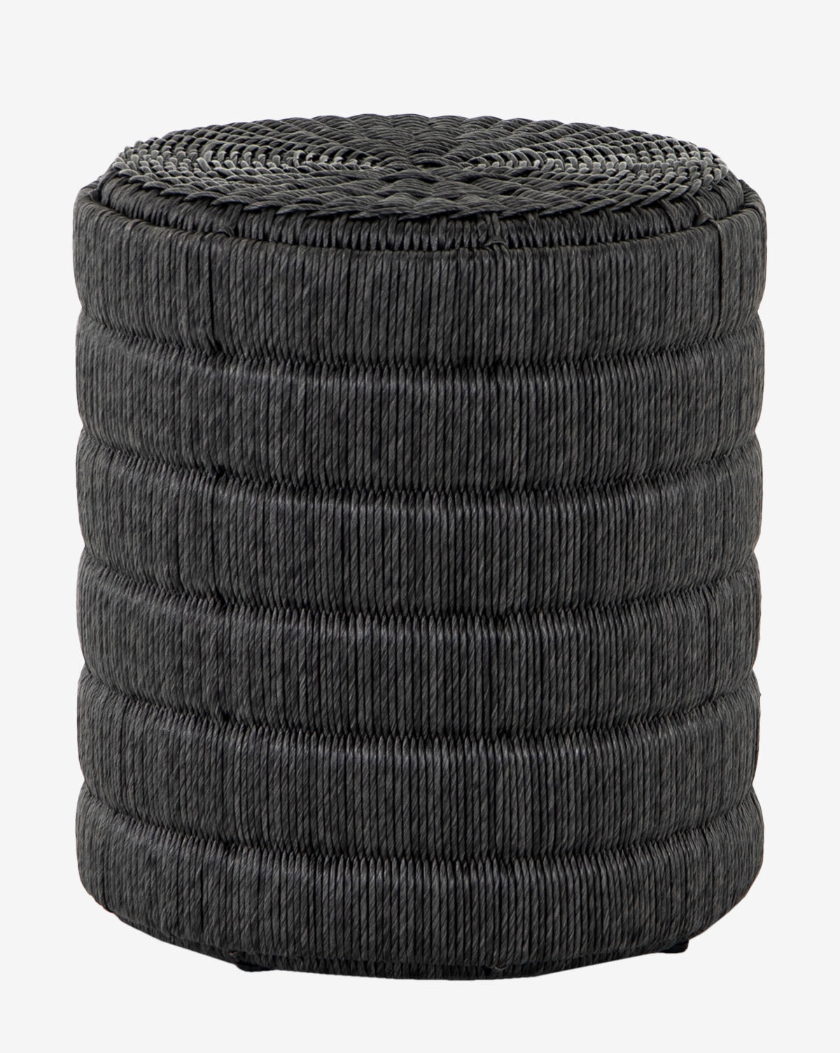The Emiliano Side Table is a round, black ottoman made from all-weather wicker with a ribbed texture and flat top, ideal as an outdoor side table or extra seat, by McGee & Co.