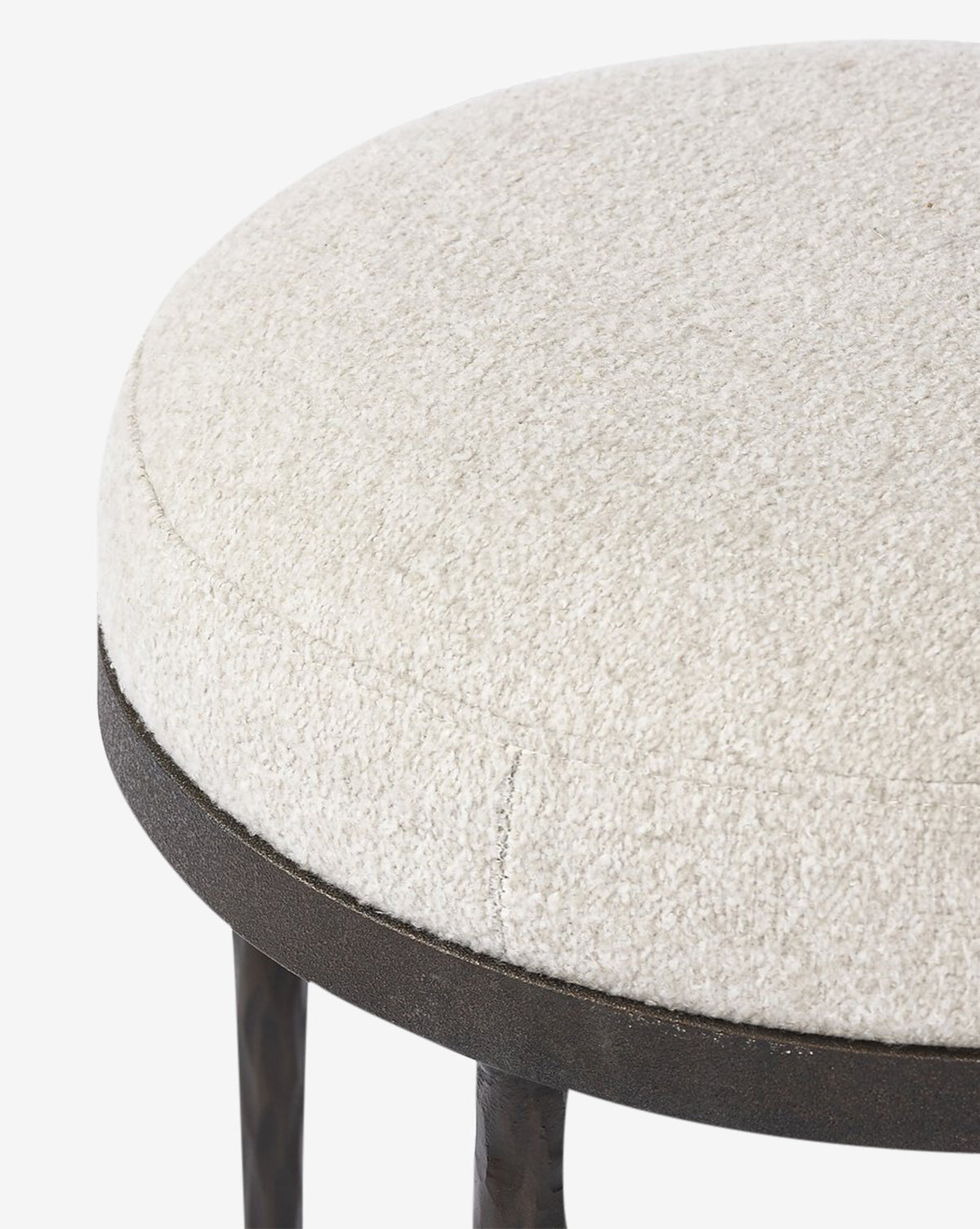 Close-up of the Emmett Stool by Four Hands, featuring a round, textured off-white upholstered seat and a dark metal frame—an ideal accent piece for any space. McGee & Co.
