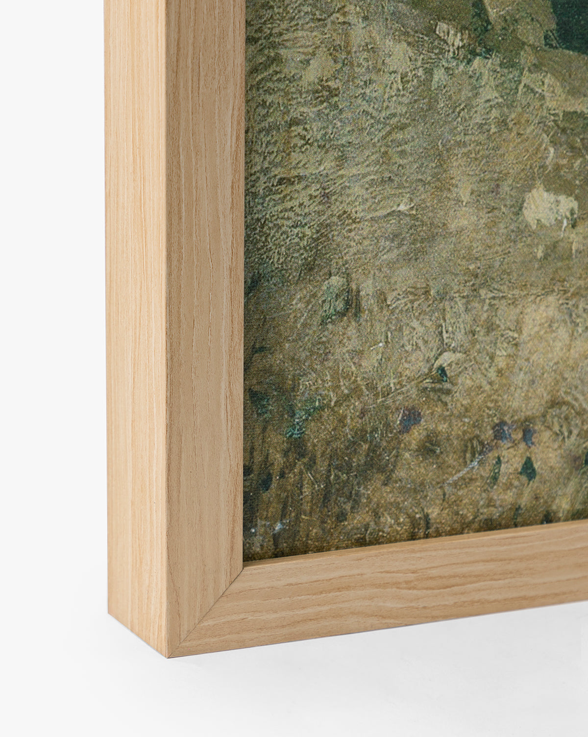 Close-up of the bottom left corner of a natural oak wood frame featuring English Meadows, a green and brown textured countryside landscape giclee on canvas, set against a plain white background, by McGee & Co.