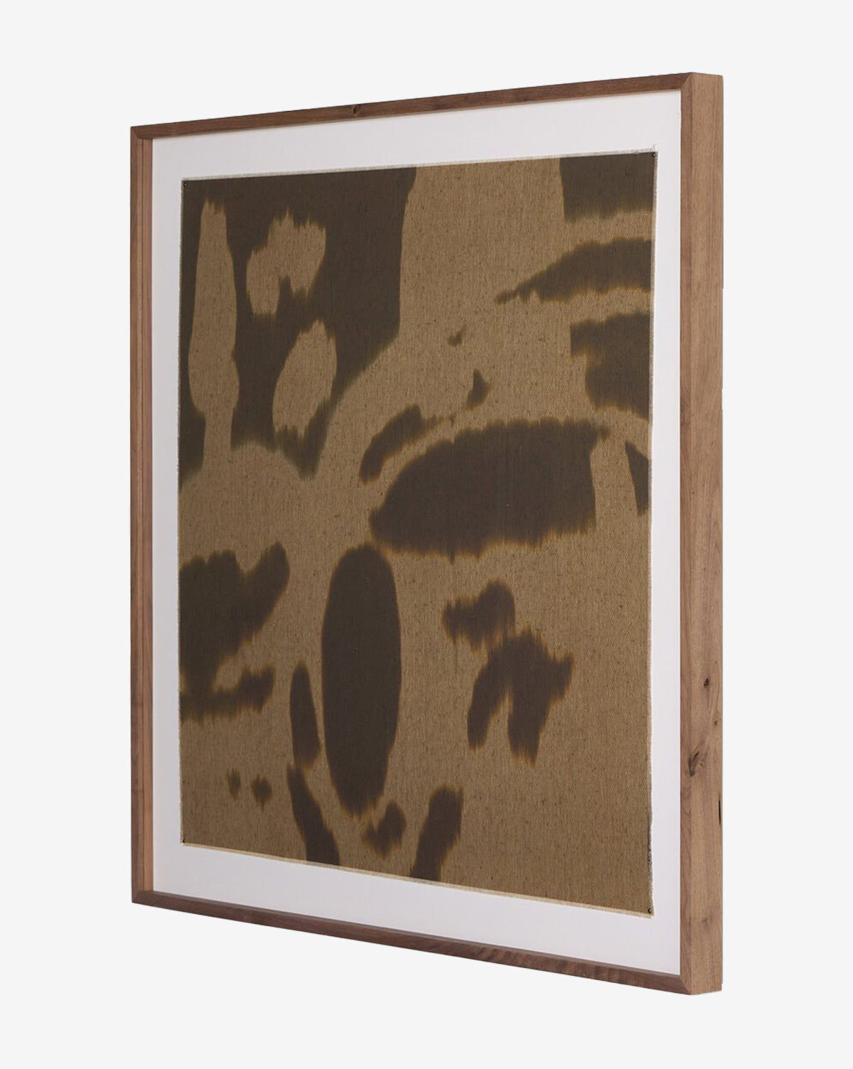 Enigmatic 2 by Shatha Al Dafai is a framed abstract artwork featuring irregular dark brown shapes on textured raw canvas, set in a simple wooden frame with crisp white matting, by McGee & Co.