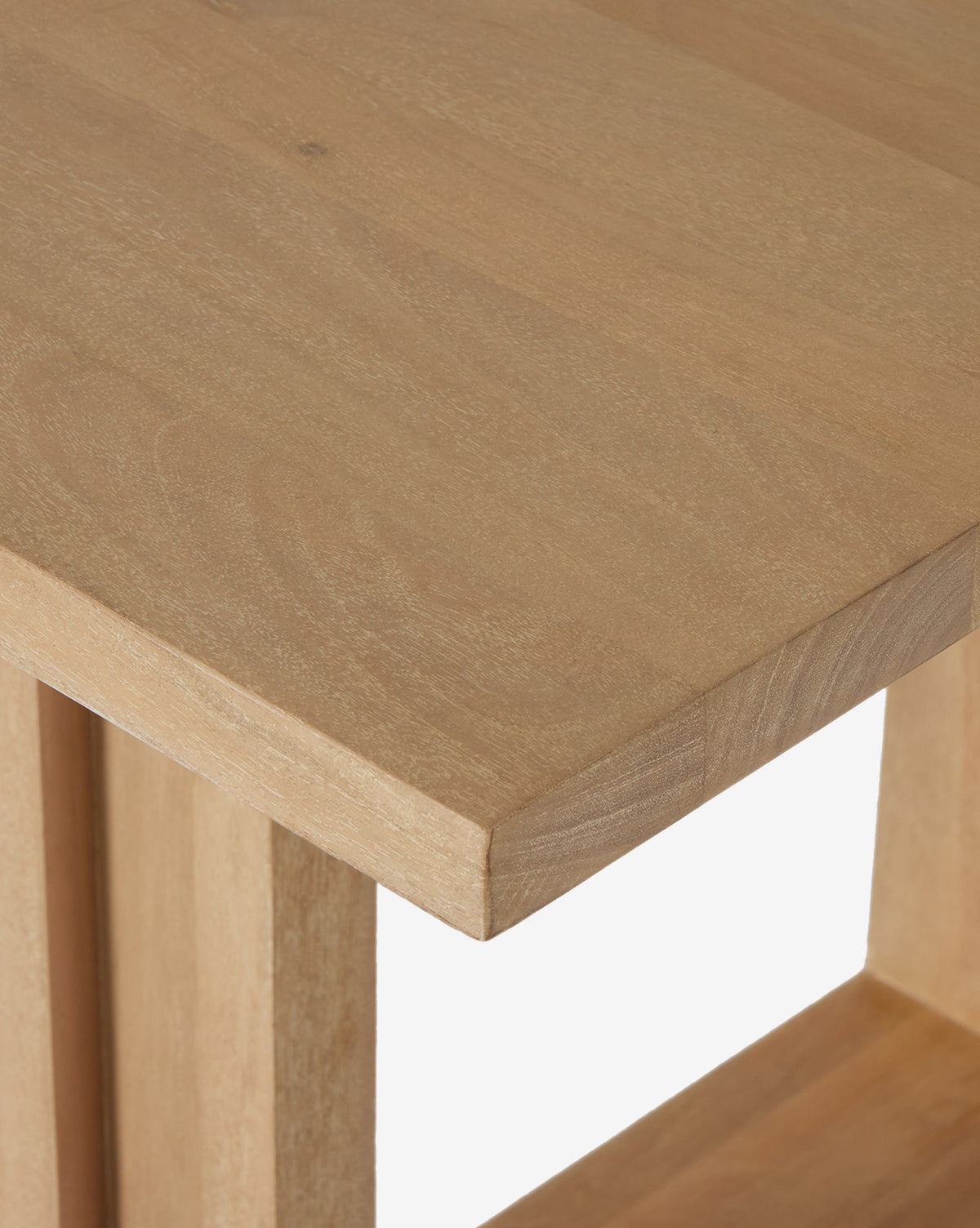 Close-up of the Ernie Dining Table, a modern piece featuring solid mango wood, clean lines, and visible wood grain, by McGee & Co.