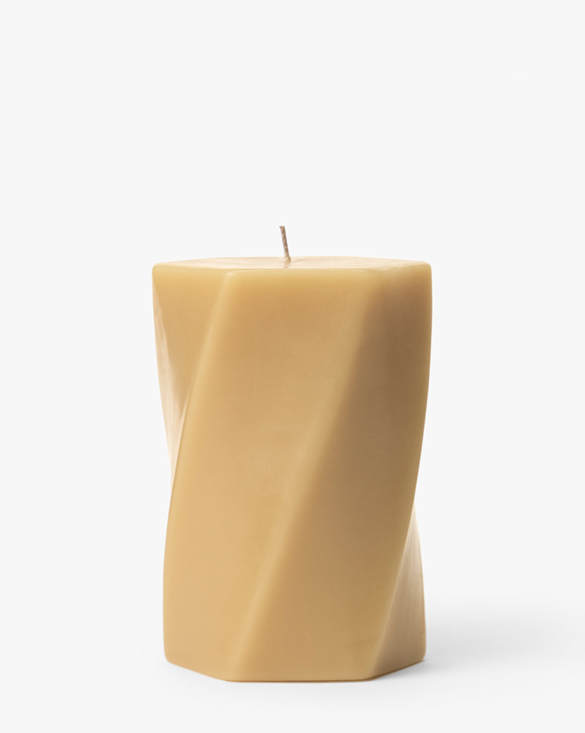 The Errol Wax Pillar Candle is a beige, square-shaped candle with a twisted design, displayed upright on a white background—perfect for adding a modern touch to any space, by McGee & Co.