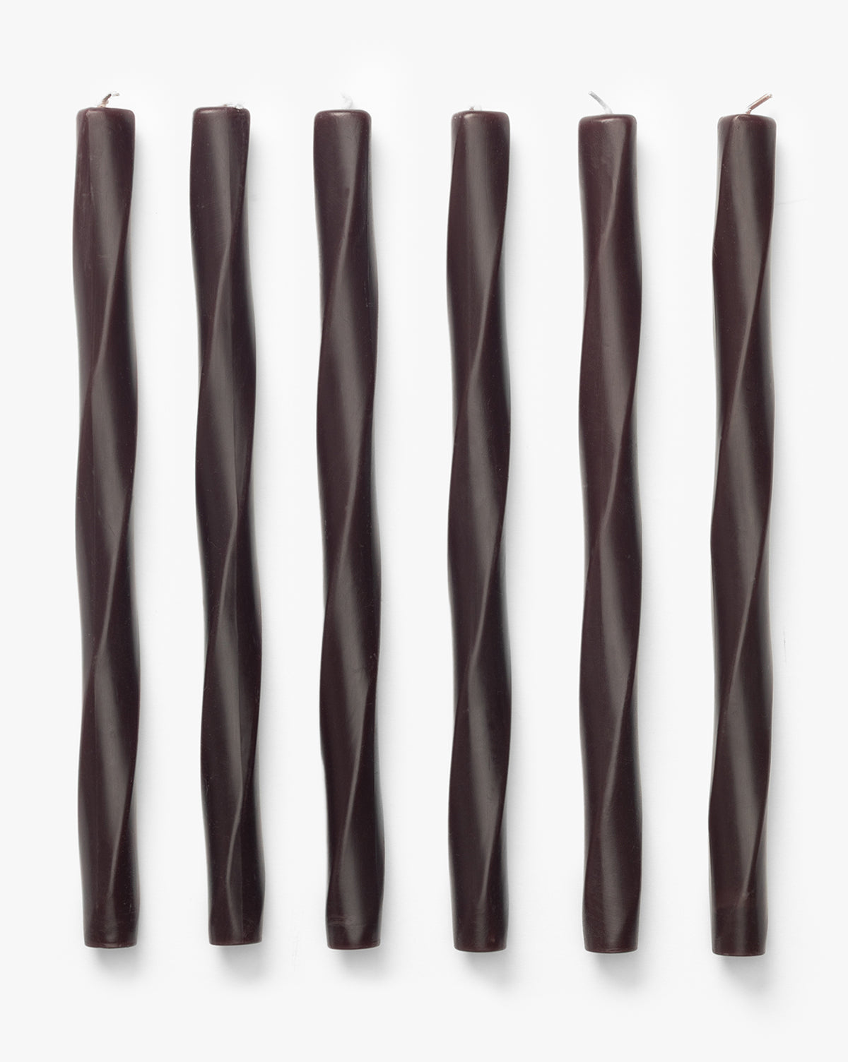 Six Errol Wax Tapers (Set of 6) in dark brown, featuring sculptural twisted designs, are arranged vertically in a row on a plain white background, by McGee & Co.