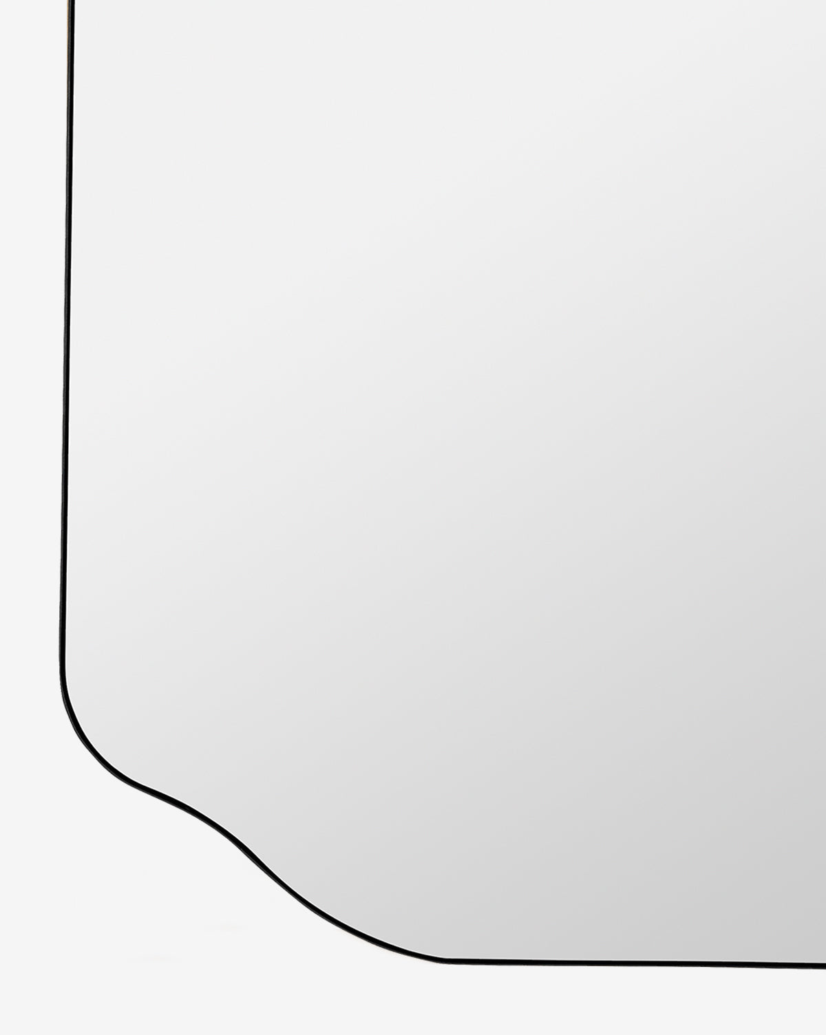 A close-up of the Ethel Wall Mirror, featuring an elegant black metal frame with a decorative curved edge, set against a plain white background, by McGee & Co.