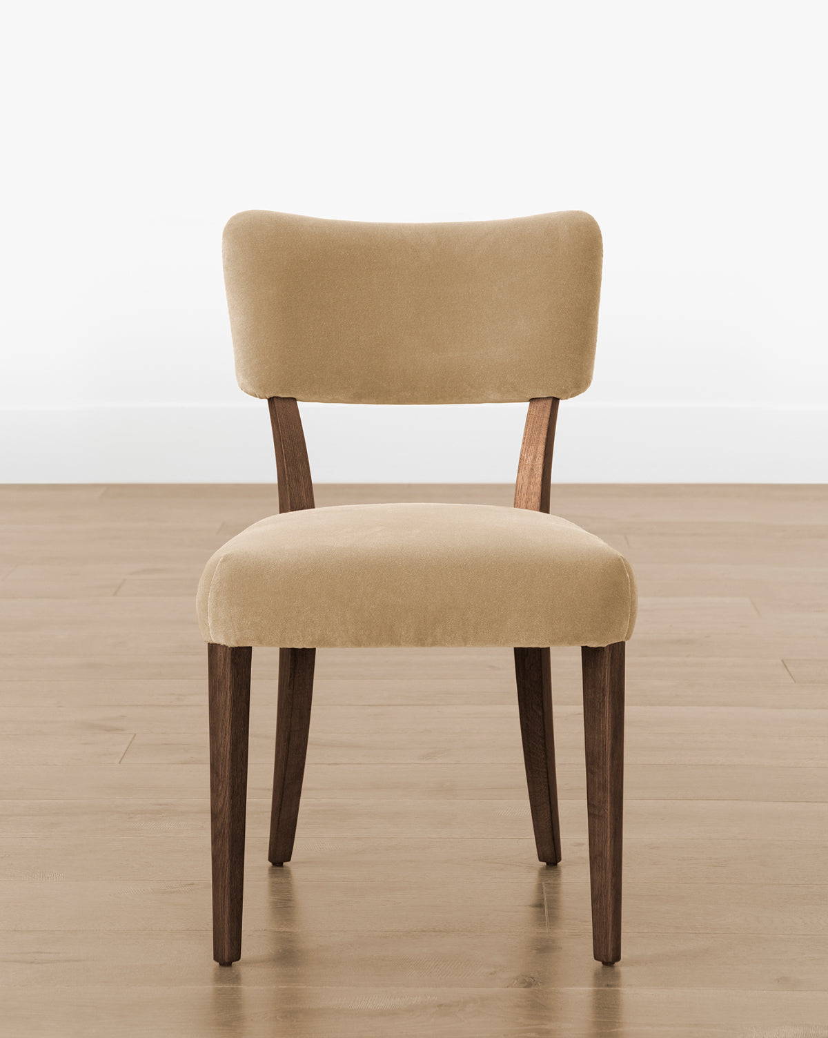 The Makerspalm Etienne Dining Chair (Ready to Ship) offers a light beige upholstered seat and backrest, dark wooden legs, and a minimalist design—ideal for bringing timeless elegance to any space. McGee & Co.