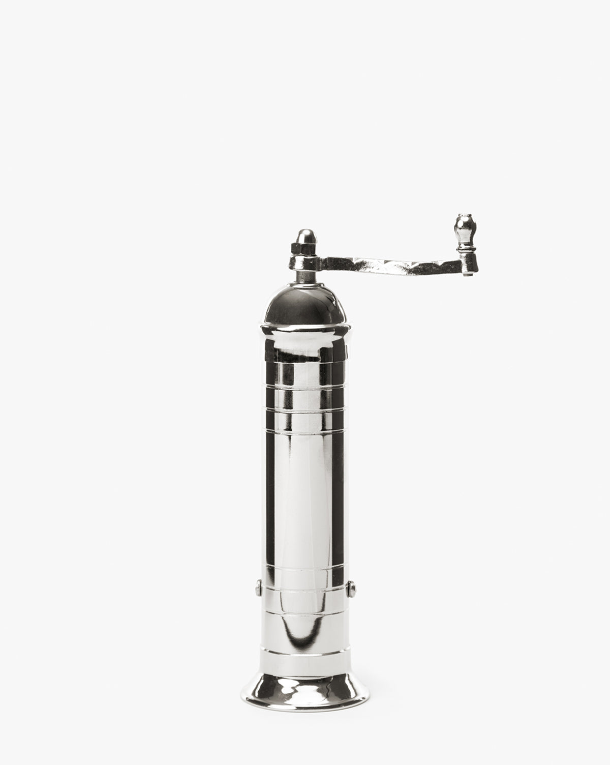 The European Chrome Pepper Mill features a tall, shiny silver cylindrical body, a horizontal top handle, and an adjustable steel grinding mechanism, all set against a plain white background by McGee & Co.