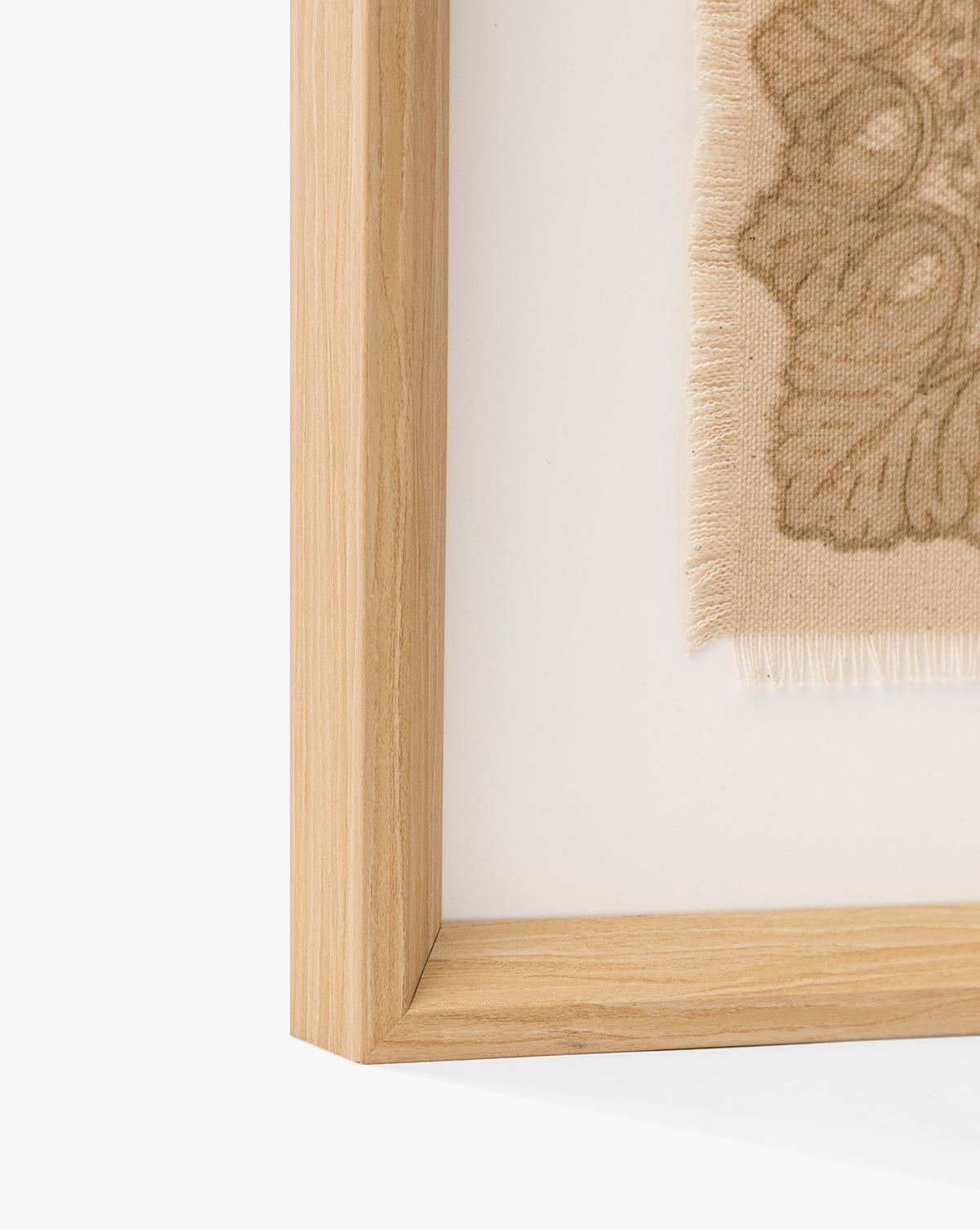 Close-up of the European Flare frame highlights its natural woodgrain and vintage-style wall art—a beige fabric with a decorative floral pattern—bringing elegant European charm to any space, by McGee & Co.