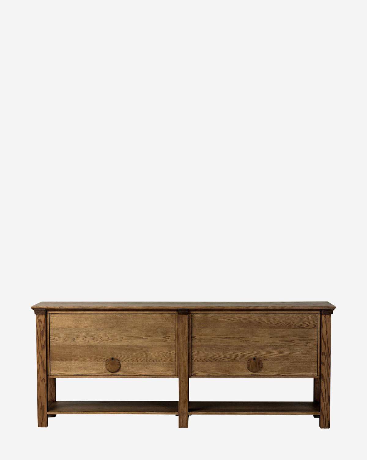 The Evaline Sideboard features a solid oak build with two spacious drawers, each adorned with round black iron pulls. Its minimalist design and natural medium-brown finish offer a classic alternative to traditional oak sideboards, by McGee & Co.