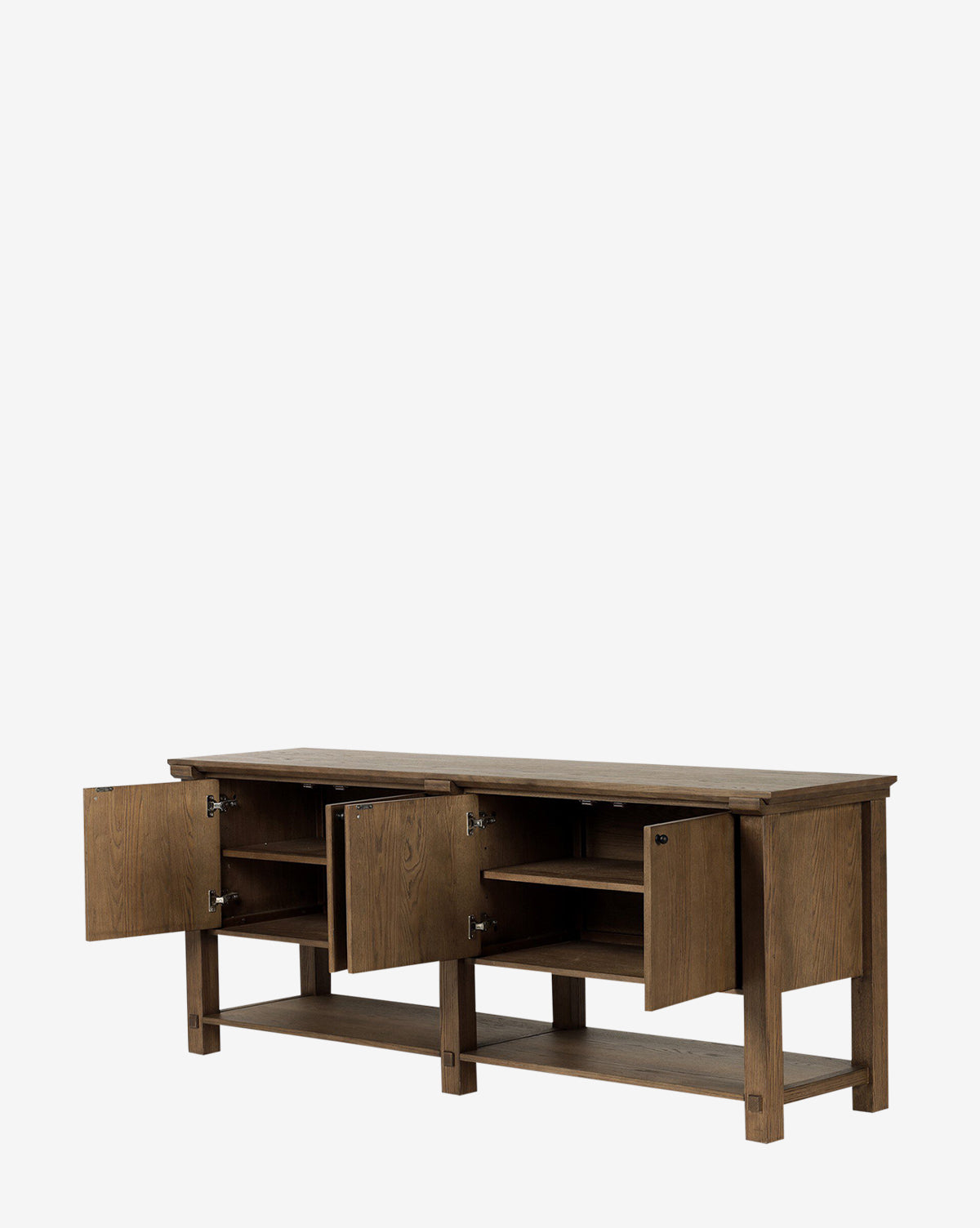The Evaline Sideboard is a solid oak piece with four cabinet doors that open to reveal shelves inside. It features black iron hardware, a lower open shelf, and a rectangular shape with a natural wood finish, by McGee & Co.