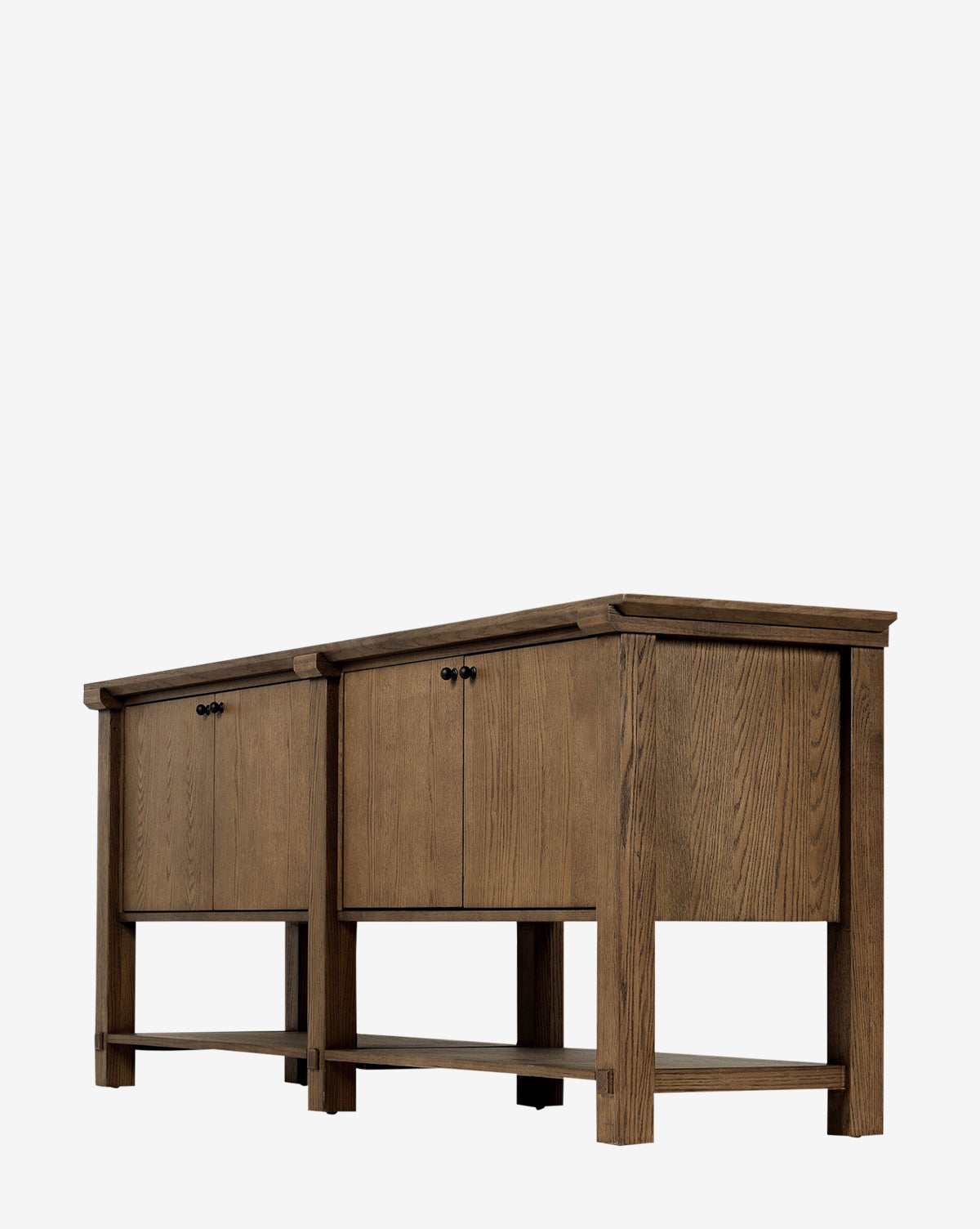 Two Evaline Sideboards with rustic finishes, each featuring double doors with black iron hardware and an open lower shelf, are placed side by side on a white background by McGee & Co.