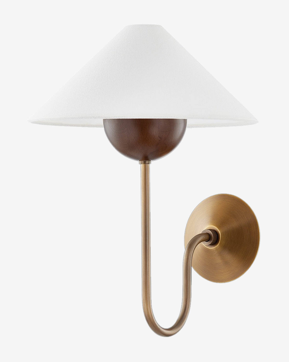The Evan Sconce by Troy Lighting showcases a patina brass finish, curved arm, round backplate, dark wood accent, and wide white linen shade for timeless elegance. McGee & Co.
