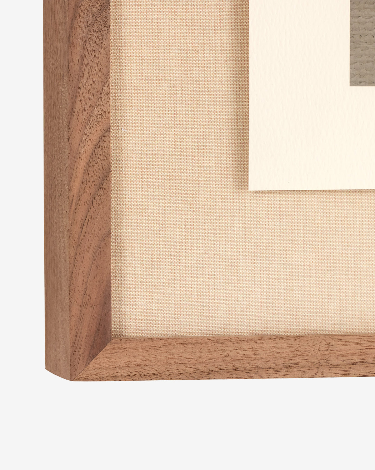 Close-up of the corner of a walnut frame with a beige fabric mat and a glimpse of the Abstract Ombre No. 5 by Roseanne Kenny fine art print on white textured paper.