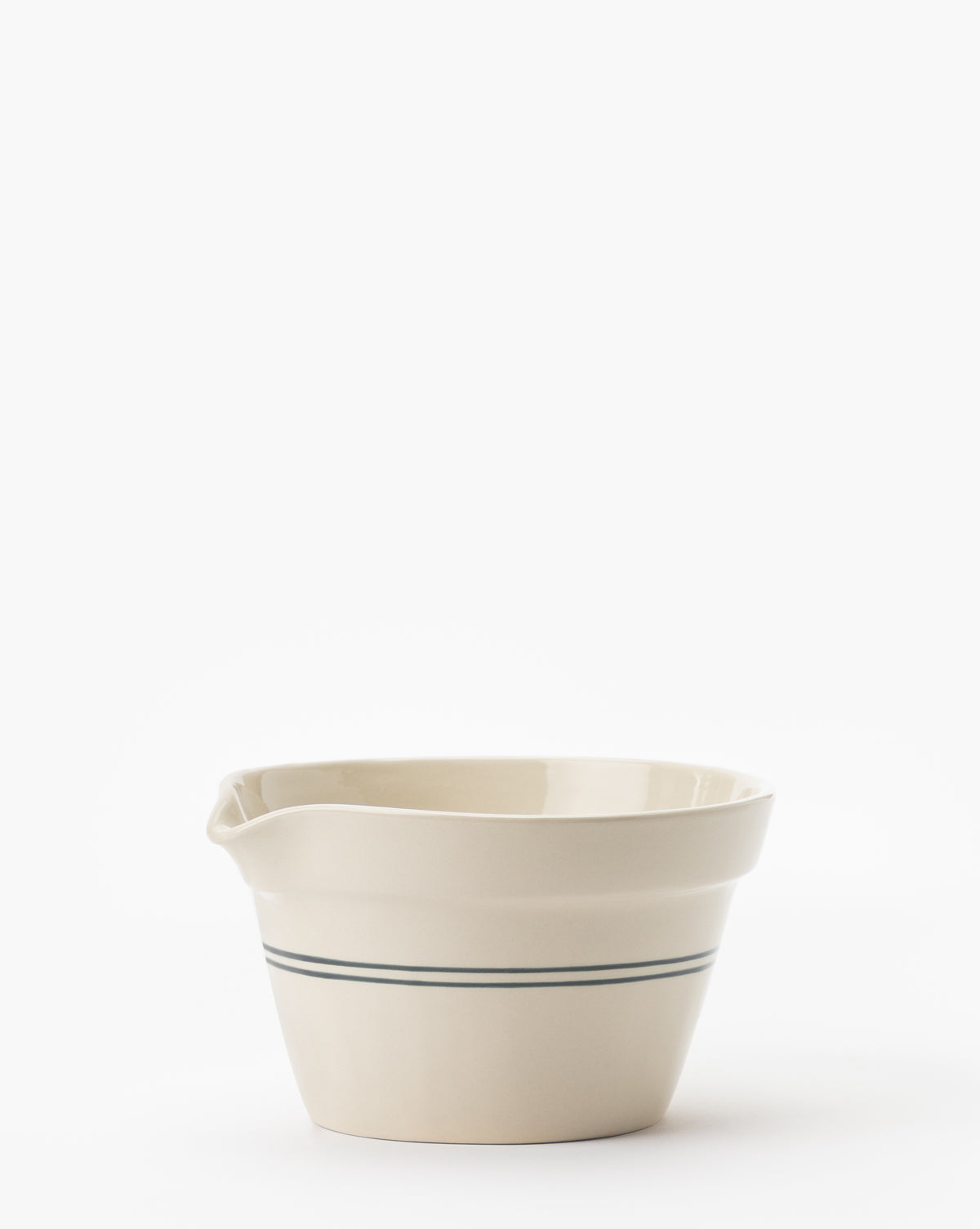 The Everett Mixing Bowl, cream-colored with two thin green stripes near the base and a spout on one side, is displayed against a plain white background by McGee & Co.