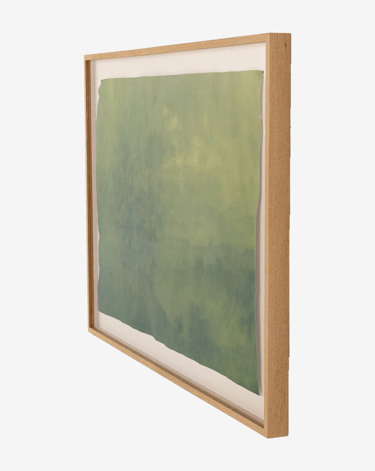 Side view of Expanse by Aileen Fitzgerald, a framed abstract watercolor in green tones with irregular edges and museum-quality detail, displayed in a light wooden frame against a white background.