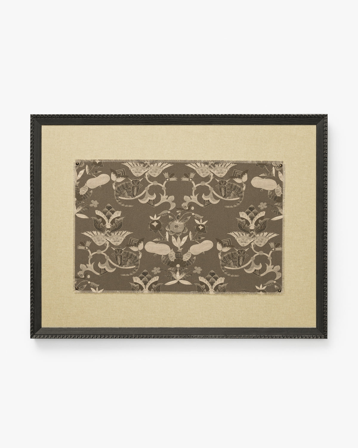 Fable is a framed canvas artwork with a beige mat and a central brown patterned textile showcasing symmetrical birds, flowers, and botanical motifs. It’s finished with a black textured-edge frame for added depth, by McGee & Co.