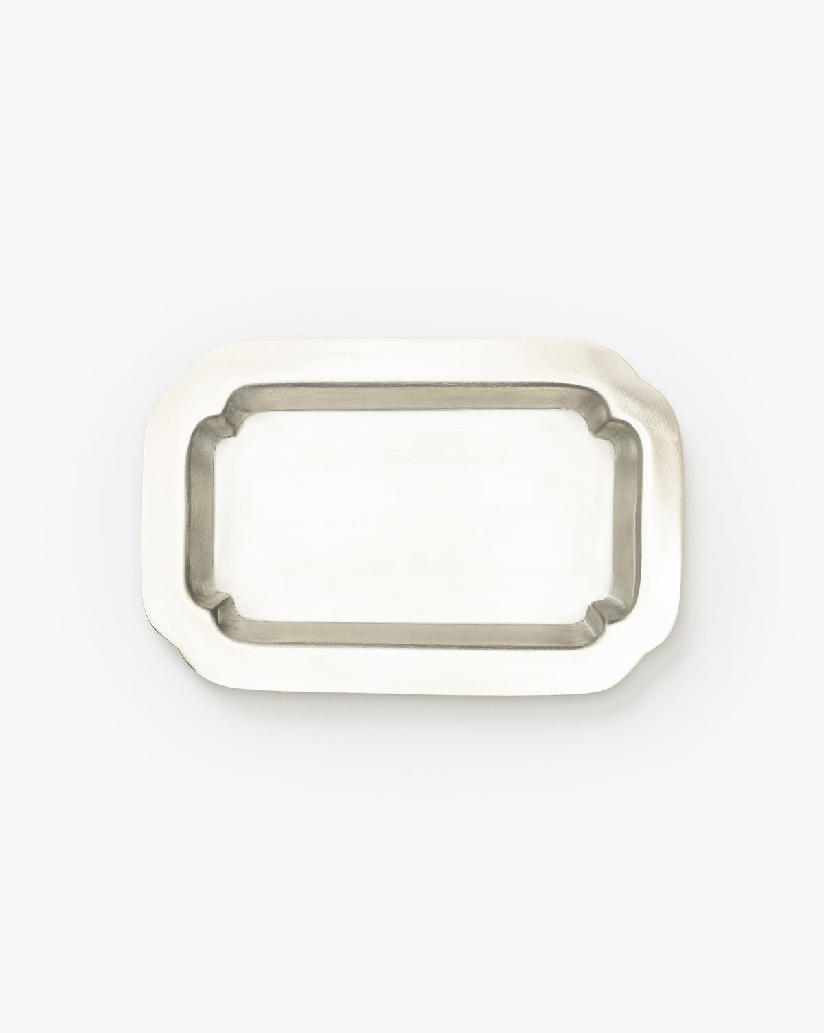 The Feliciano Silver Tray is a rectangular silver tray with slightly raised edges and rounded corners, shown from above on a plain white background—a vintage-inspired decorative accessory for any setting, by McGee & Co.