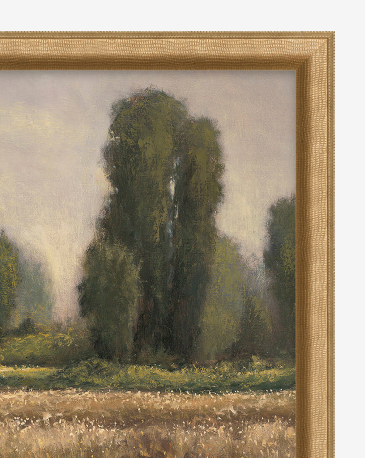 A close-up of Field in Summer vintage wall art shows tall green trees and grassy fields beneath a hazy sky, bordered by a golden-brown wooden frame—ideal for classic home decor.