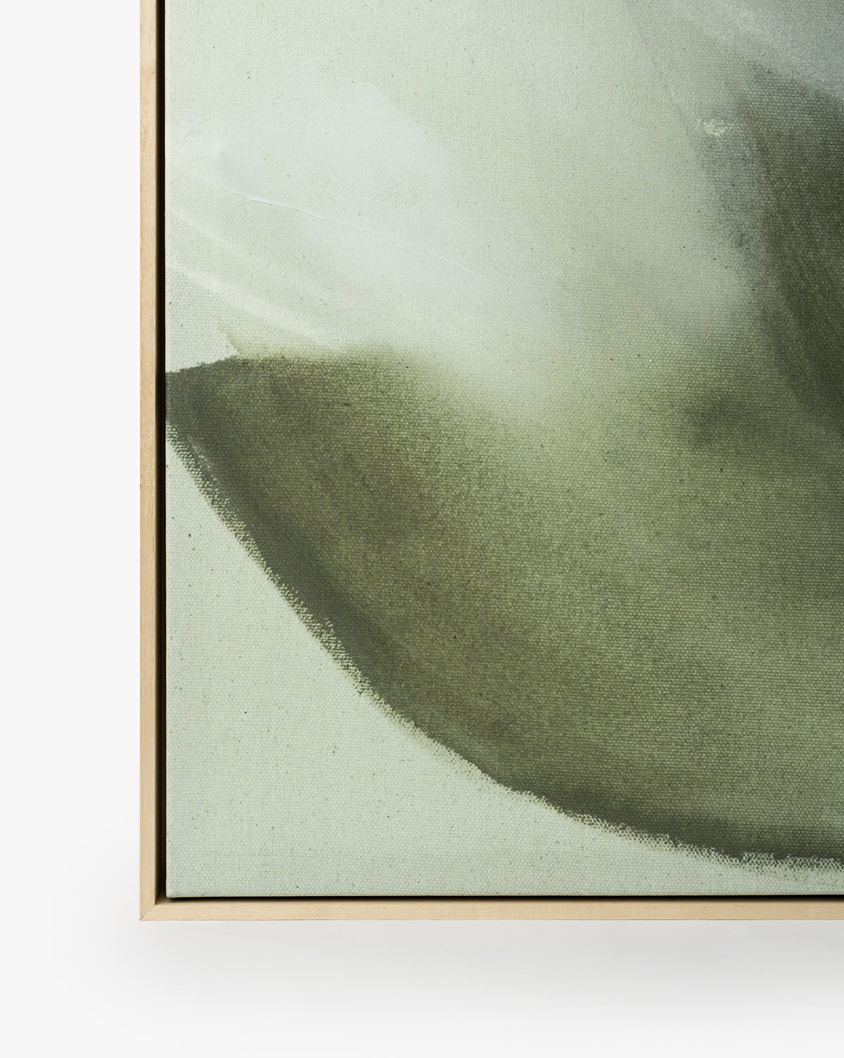 Close-up of Fields of Green, a minimalist abstract art giclee print featuring soft green and gray hues, framed in light wood against a white background, by McGee & Co.