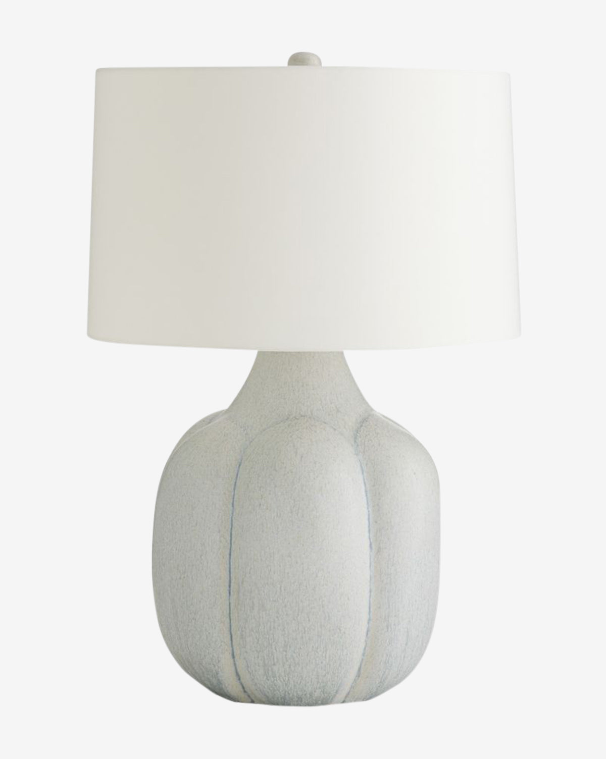 The Arteriors Fig Table Lamp showcases a grooved light gray ceramic base and a plain white cylindrical shade, accented with subtle antique brass hardware. McGee & Co.