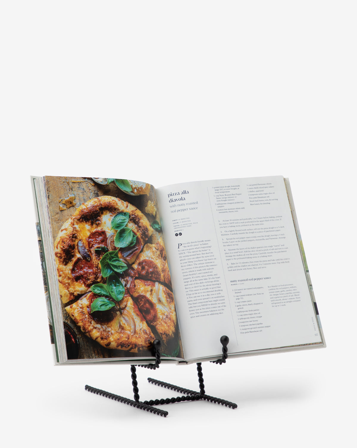 The Finlay Cookbook Holder displays an open cookbook with a pizza recipe and basil topping, adding style to your kitchen décor against a white background.