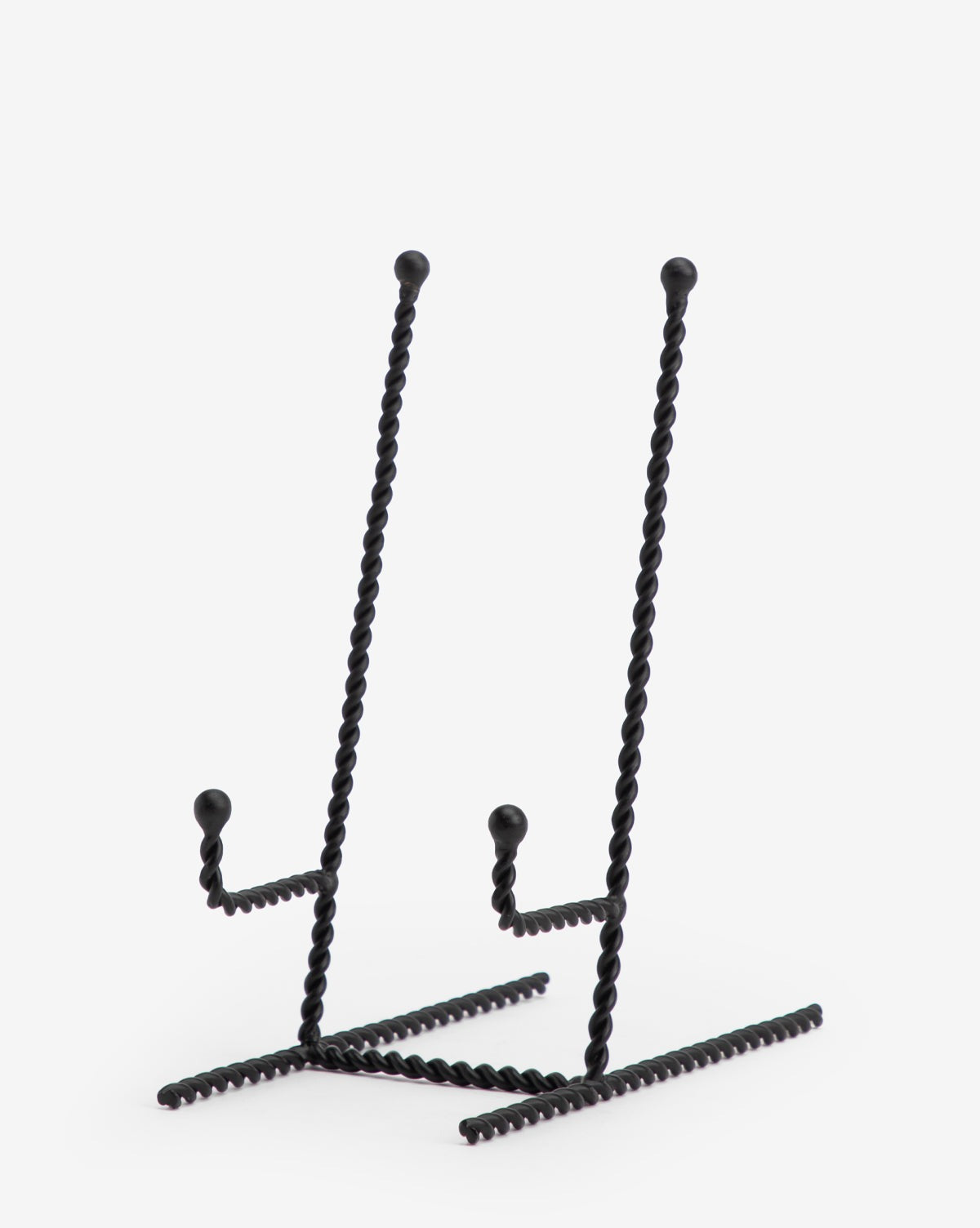 Two Finlay Cookbook Holders—black textured iron stands with angled backs and horizontal supports—are displayed side by side against a white background, perfect for adding stylish function to your kitchen.