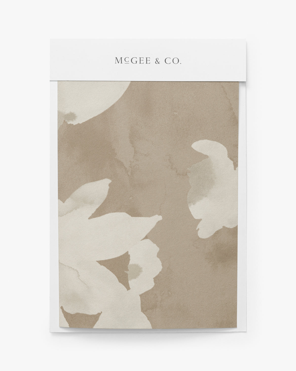 A notepad featuring a beige floral motif inspired by the Fiorella Wallpaper Swatch, with a white McGee & Co. header—perfect for adding charm to your home decor. McGee & Co.