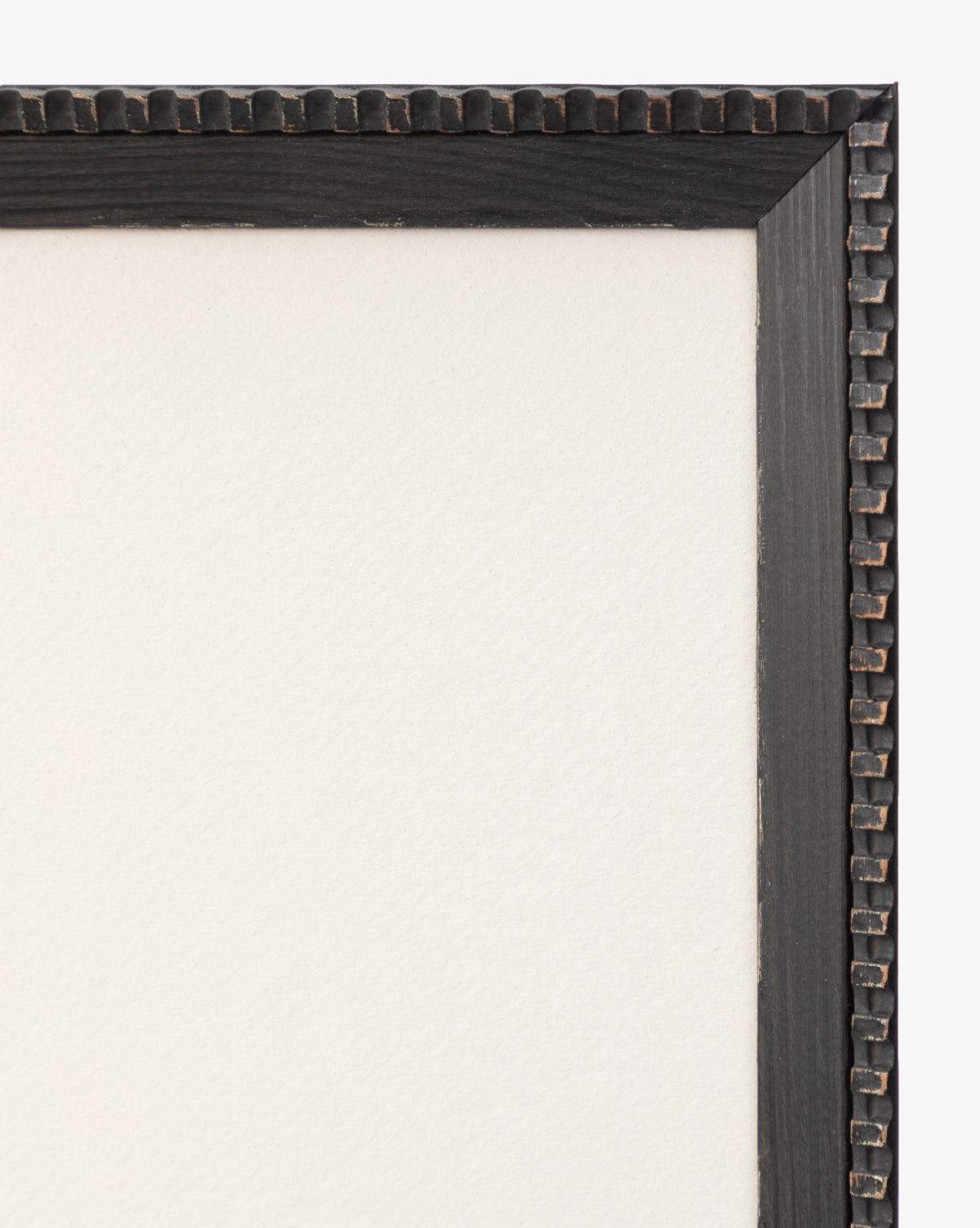 Close-up of the top right corner of a black wood frame with a beaded edge, perfect for displaying the Forest Meadow print on textured fine art paper against a blank white background.