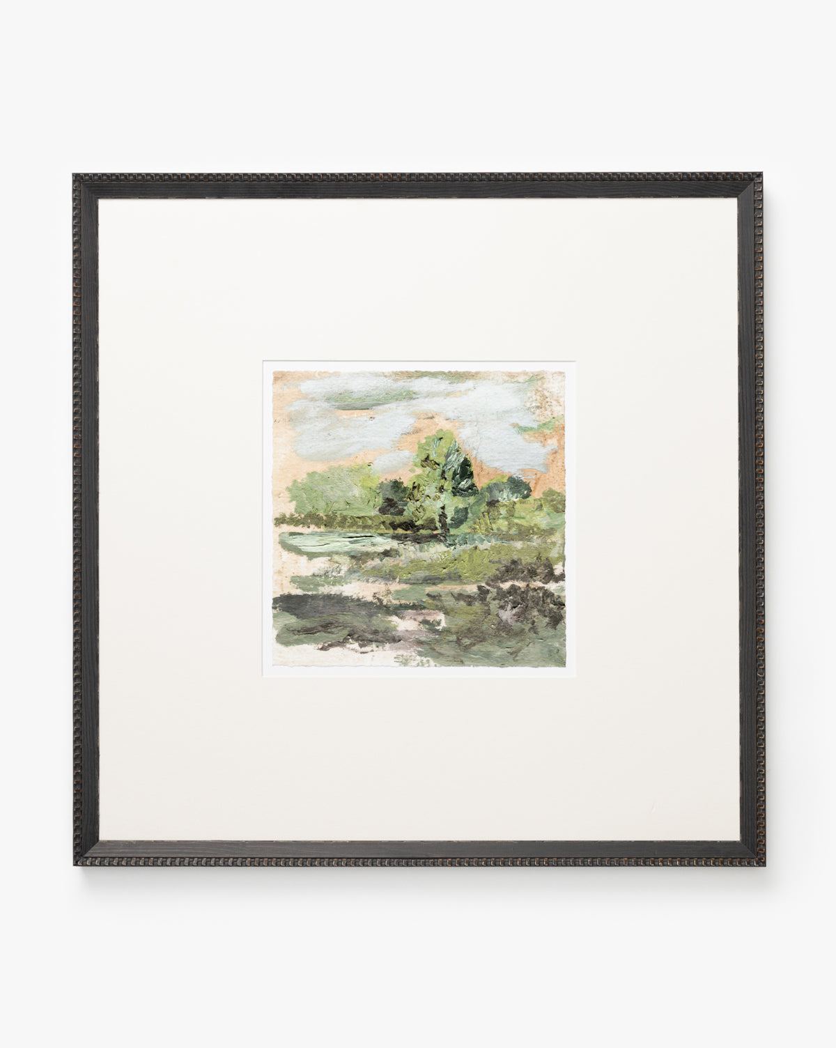 Forest Meadow is a framed watercolor print depicting green trees, a light blue sky with clouds, and grassy areas. It’s printed on textured fine art paper, set in a wide white mat, and finished with a black wood frame.