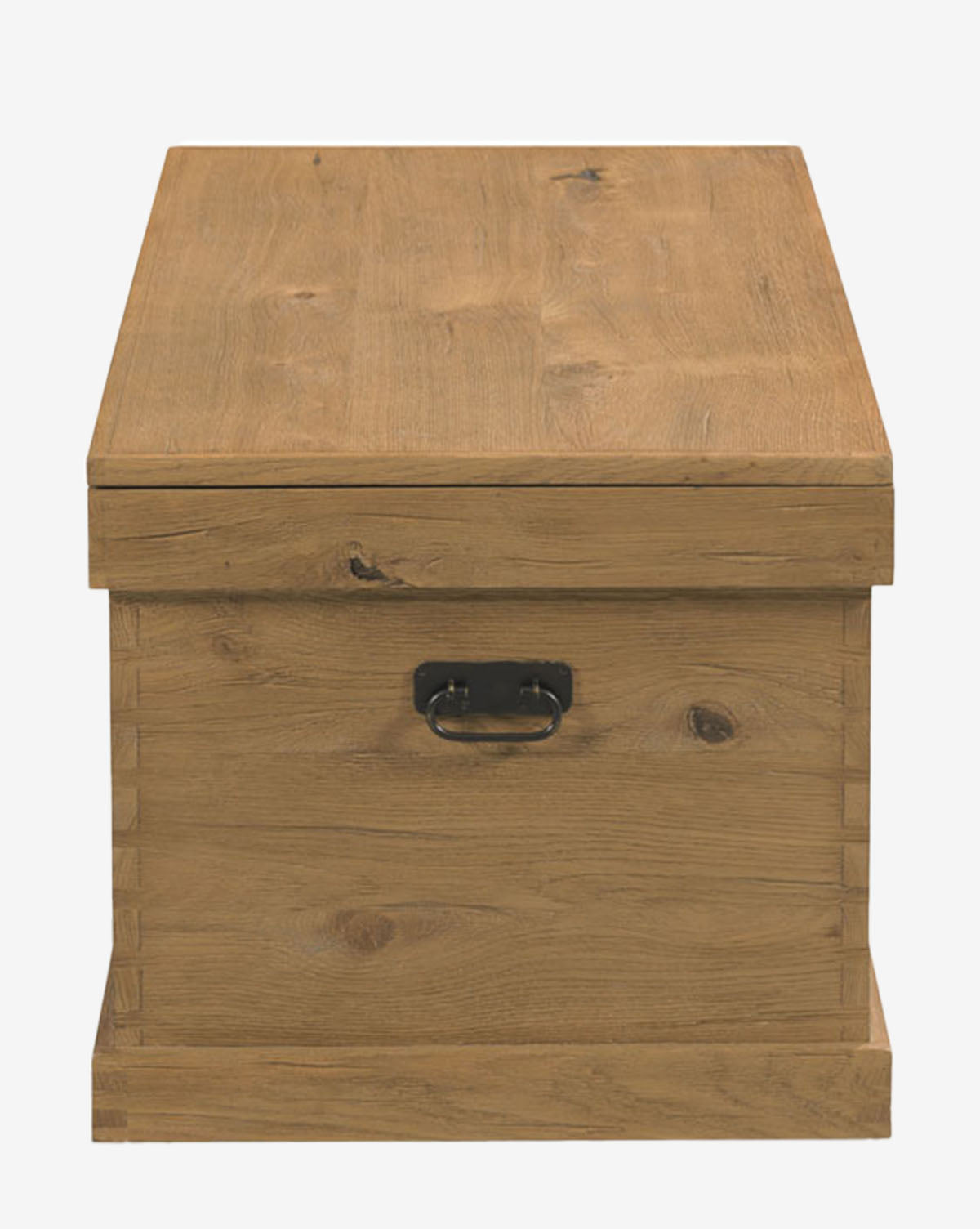 The Frances Trunk is a rectangular storage chest with a natural oak veneer, dovetail joints, hinged lid, and a black metal front handle, shown against a plain white background, by McGee & Co.