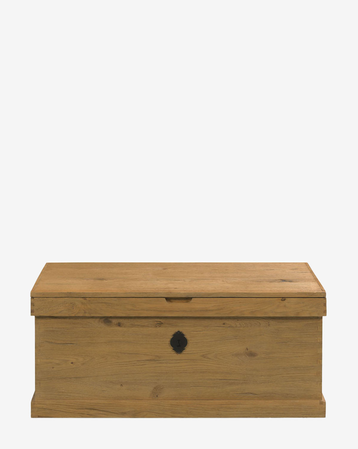 The Frances Trunk, featuring a rectangular shape, flat lid, natural oak veneer, and small black metal lock plate on the front, provides generous storage space and is shown on a plain white background by McGee & Co.