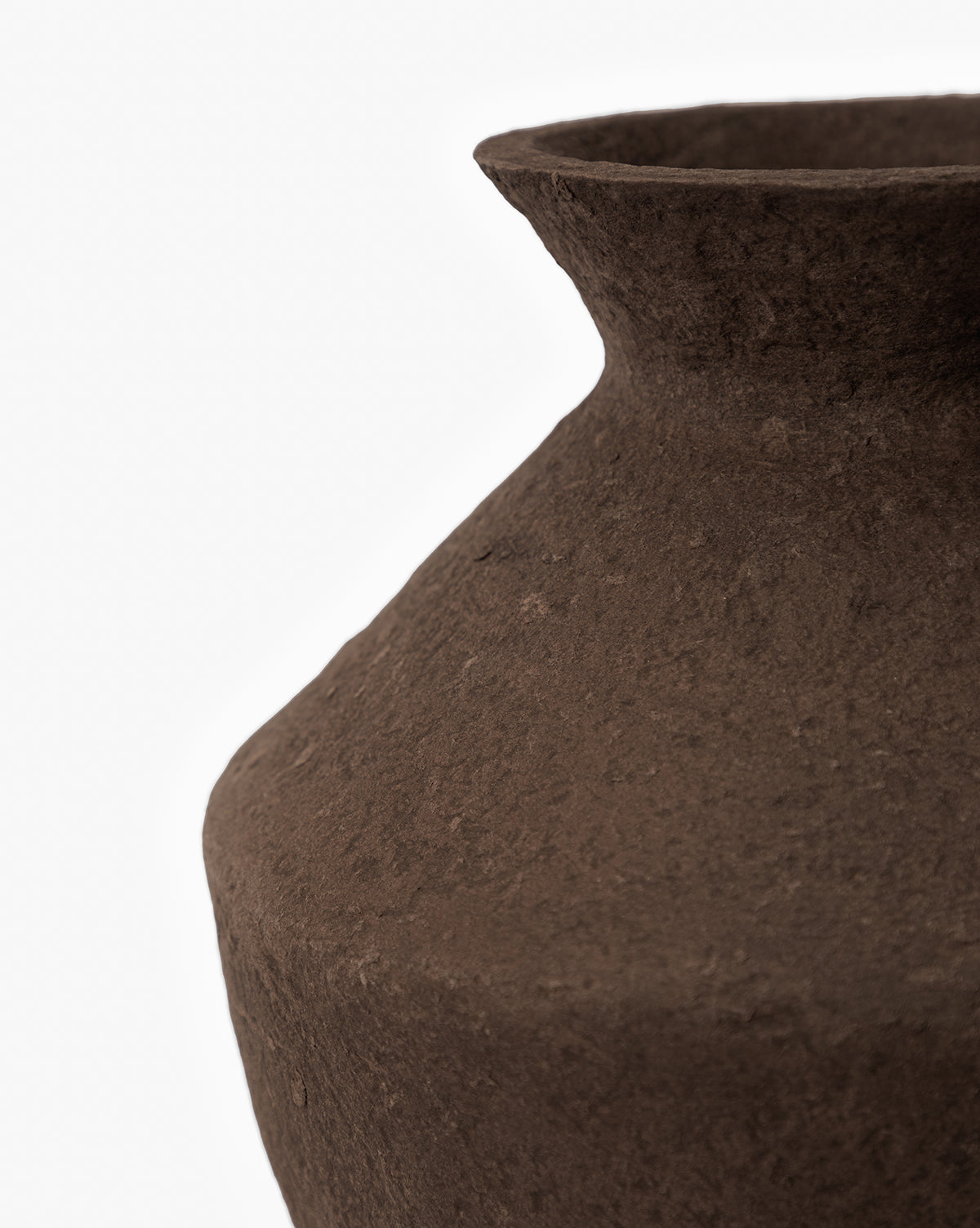 Close-up of the Frederick Paper Mache Vase, a handmade piece with a textured brown finish, wide neck, and rounded body. Partially shown against a white background to highlight its rustic surface detail, by McGee & Co.