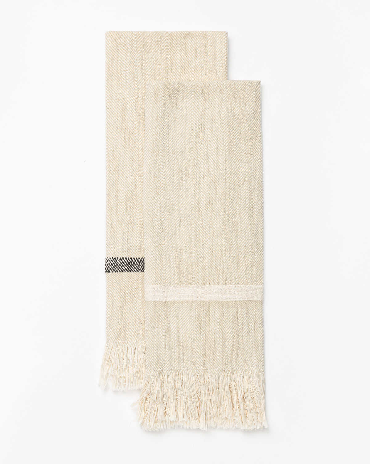 A set of two beige Fringed Striped Tea Towels, each with a subtle herringbone pattern and black-and-white detail, crafted from soft cotton with fringed edges, is displayed flat on a white background, by McGee & Co.