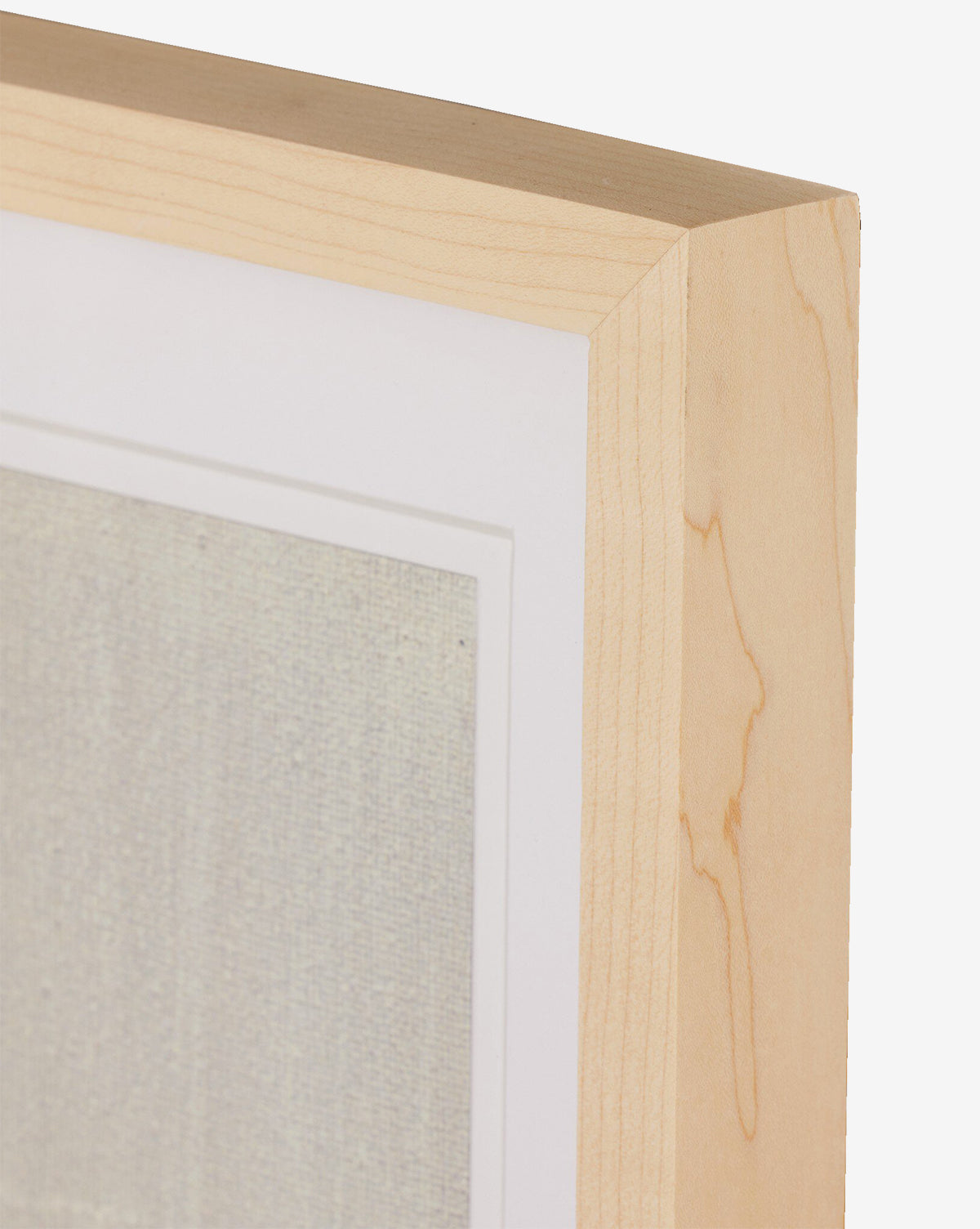 Close-up of a light wood picture frame with a white mat, highlighting Jade Dacays Galactic IV mixed media minimalist art, by McGee & Co. The textured artwork is partially visible against a plain white background.