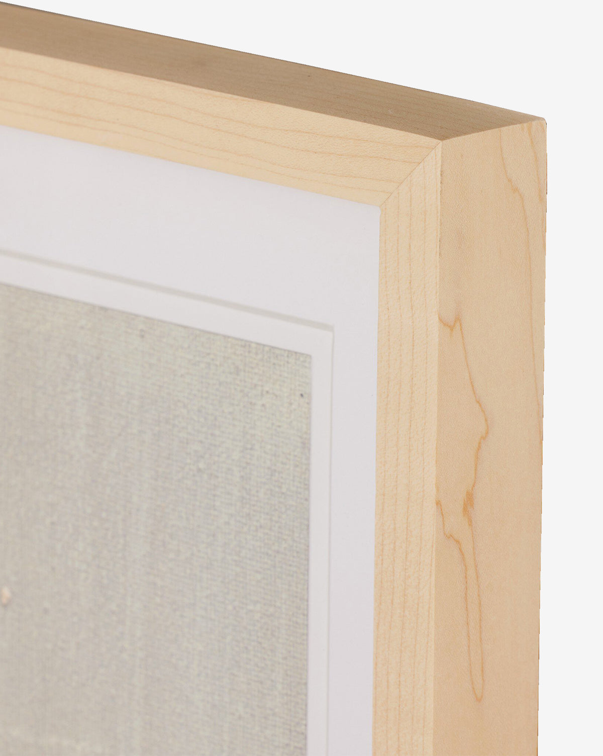 Close-up of a natural-toned frame featuring Galactic VII by Jade Dacay with a white mat, showcasing the wood grain texture and a hint of mixed media minimalist artwork inside, by McGee & Co.