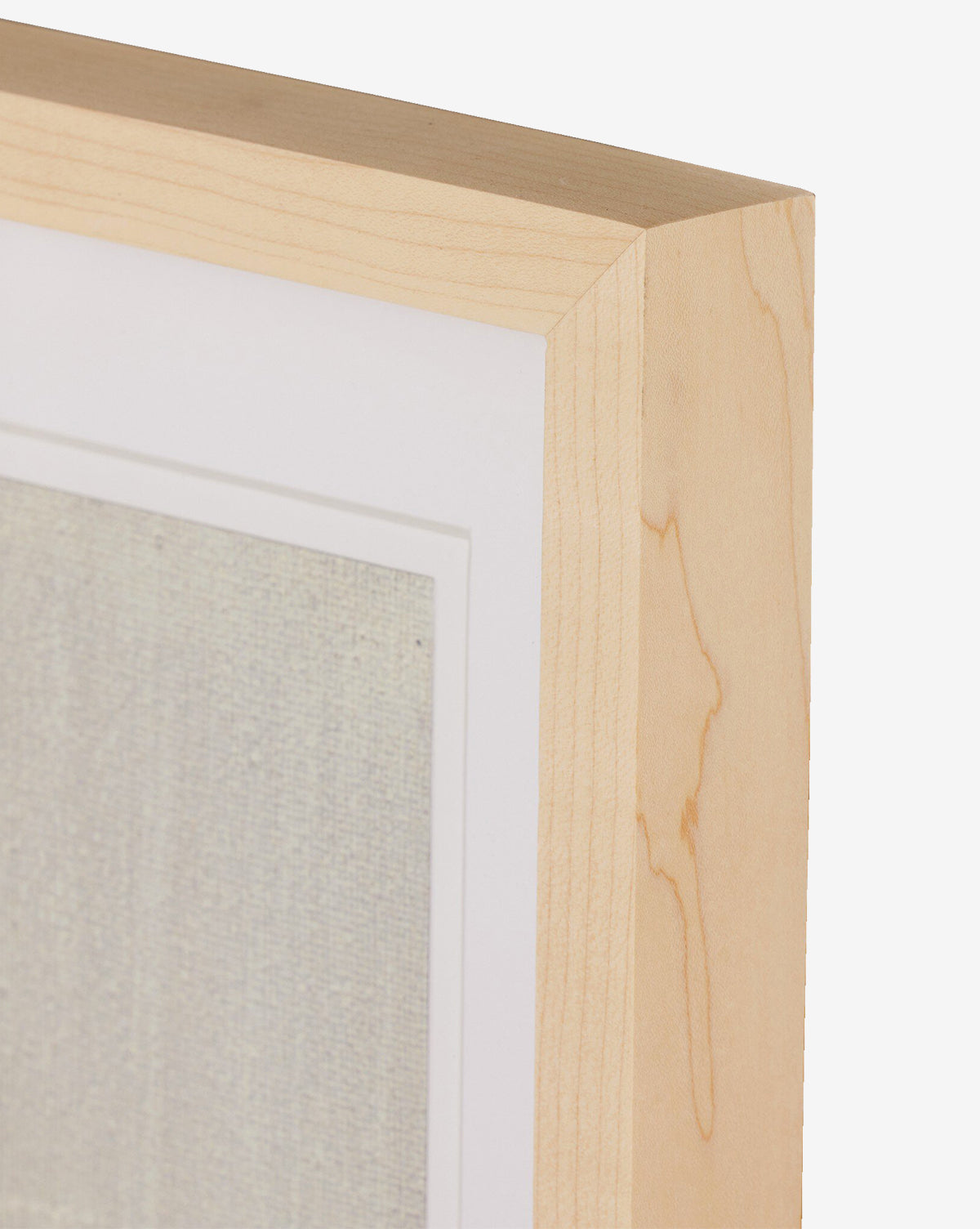 Close-up of a natural-toned frame with a white mat, showcasing Galactic VI by Jade Dacay, a textured, pale mixed media minimalist artwork set against a plain white background, by McGee & Co.