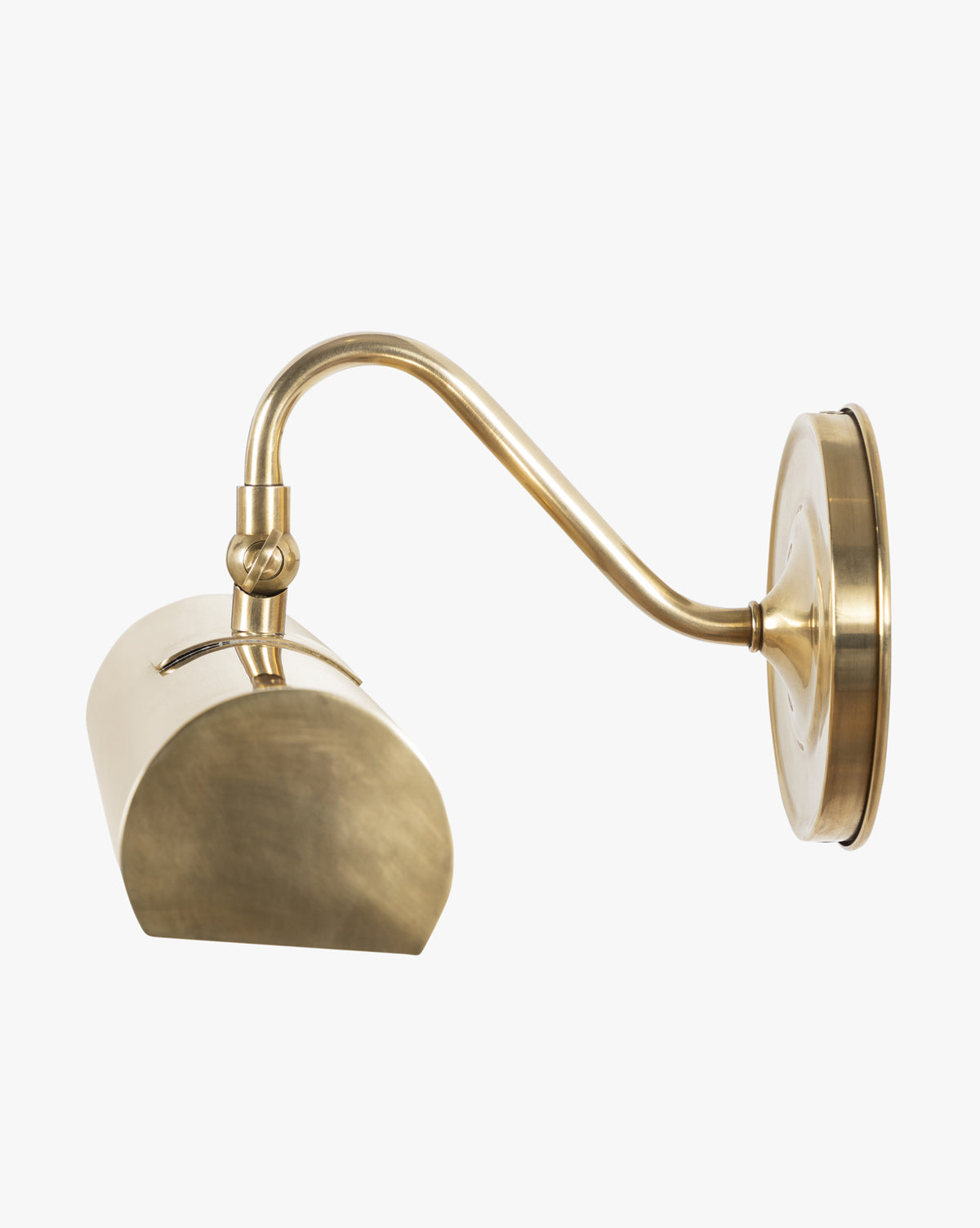 The Gallery Picture Sconce features a curved brass arm and semi-oval cylindrical shade. Its matte finish and minimalist design evoke burnished bronze, offering a modern update to the classic wall-mounted sconce style, by McGee & Co.