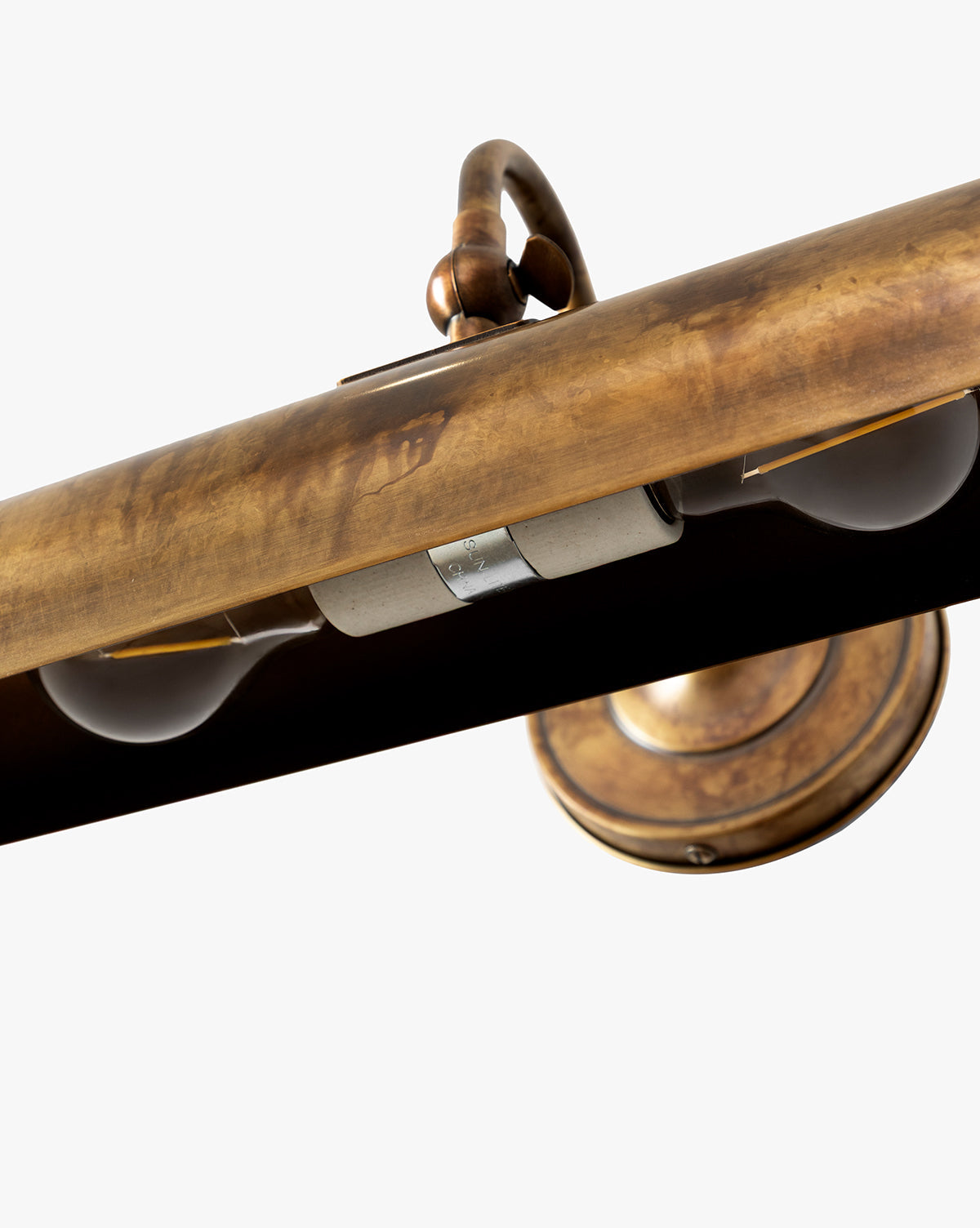 Close-up of the Gallery Picture Sconce, featuring burnished bronze details, two exposed bulbs, and a weathered antique finish for a vintage-inspired look, by McGee & Co.