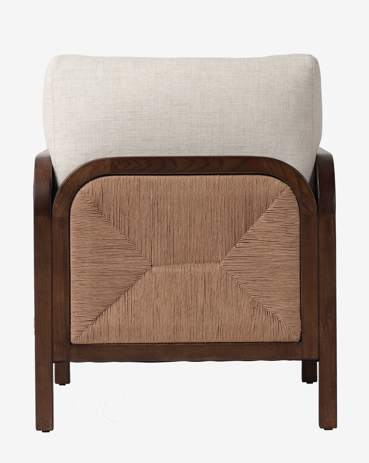 The Garvey Lounge Chair is shown from the back, highlighting a woven rattan panel, light beige upholstered cushions, and a solid ash frame with a rich dark brown finish, by McGee & Co.