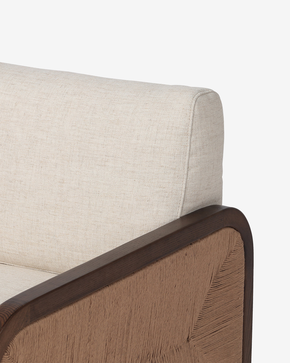 Close-up of the Garvey Lounge Chair, highlighting its solid ash frame, cream upholstery, and tan woven armrest panel against a plain white background by McGee & Co.