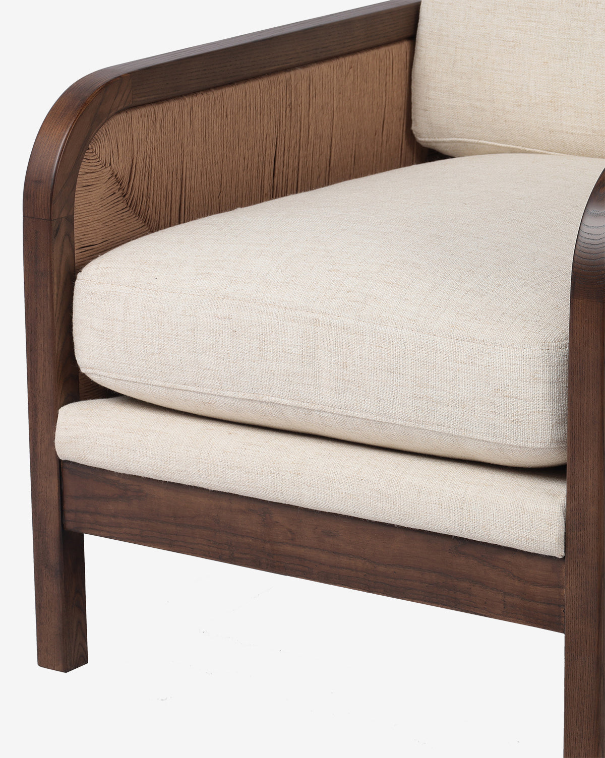 A close-up of the Garvey Lounge Chair shows its solid dark ash frame, beige upholstered cushions, and a textured brown detail on the side panel that adds stylish flair, by McGee & Co.