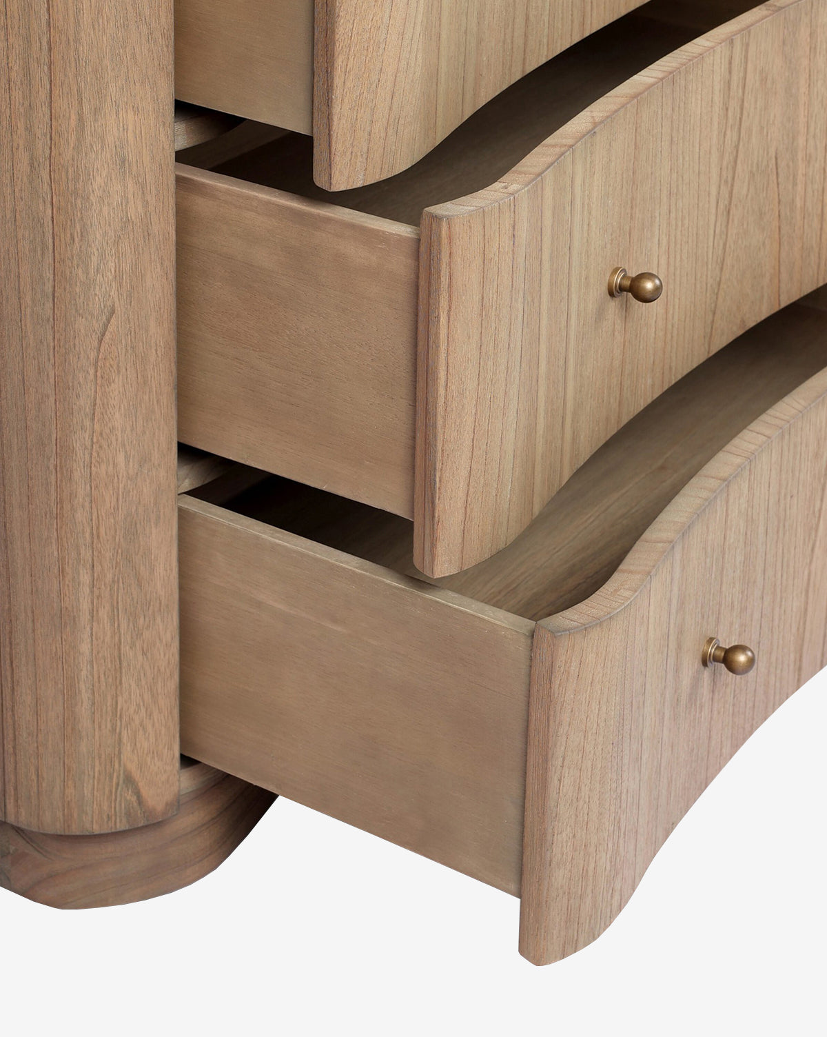 Close-up of the Gatlin Chest, made from solid mindi wood with a light natural finish, by McGee & Co. It features three spacious curved drawers and round brass knobs.