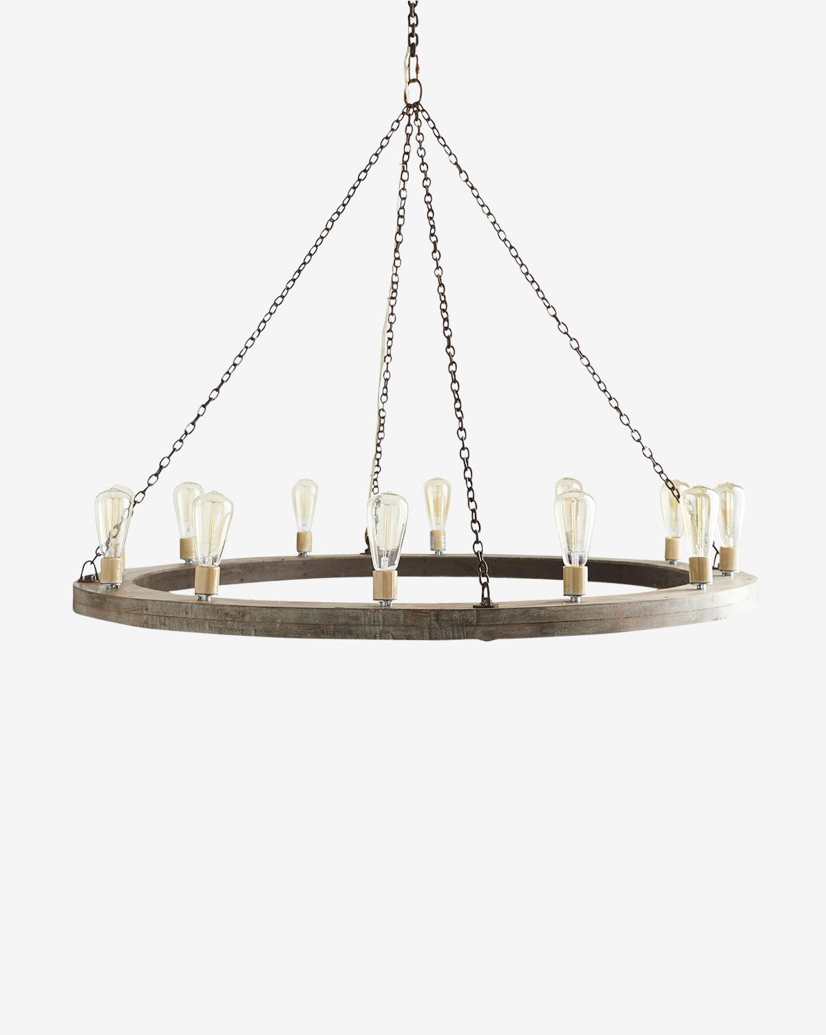 The Geoffrey Chandelier by Arteriors features twelve exposed bistro lights in an antique brass finish, arranged in a rustic circular design and suspended from three metal chains, shown on a plain white background. McGee & Co.
