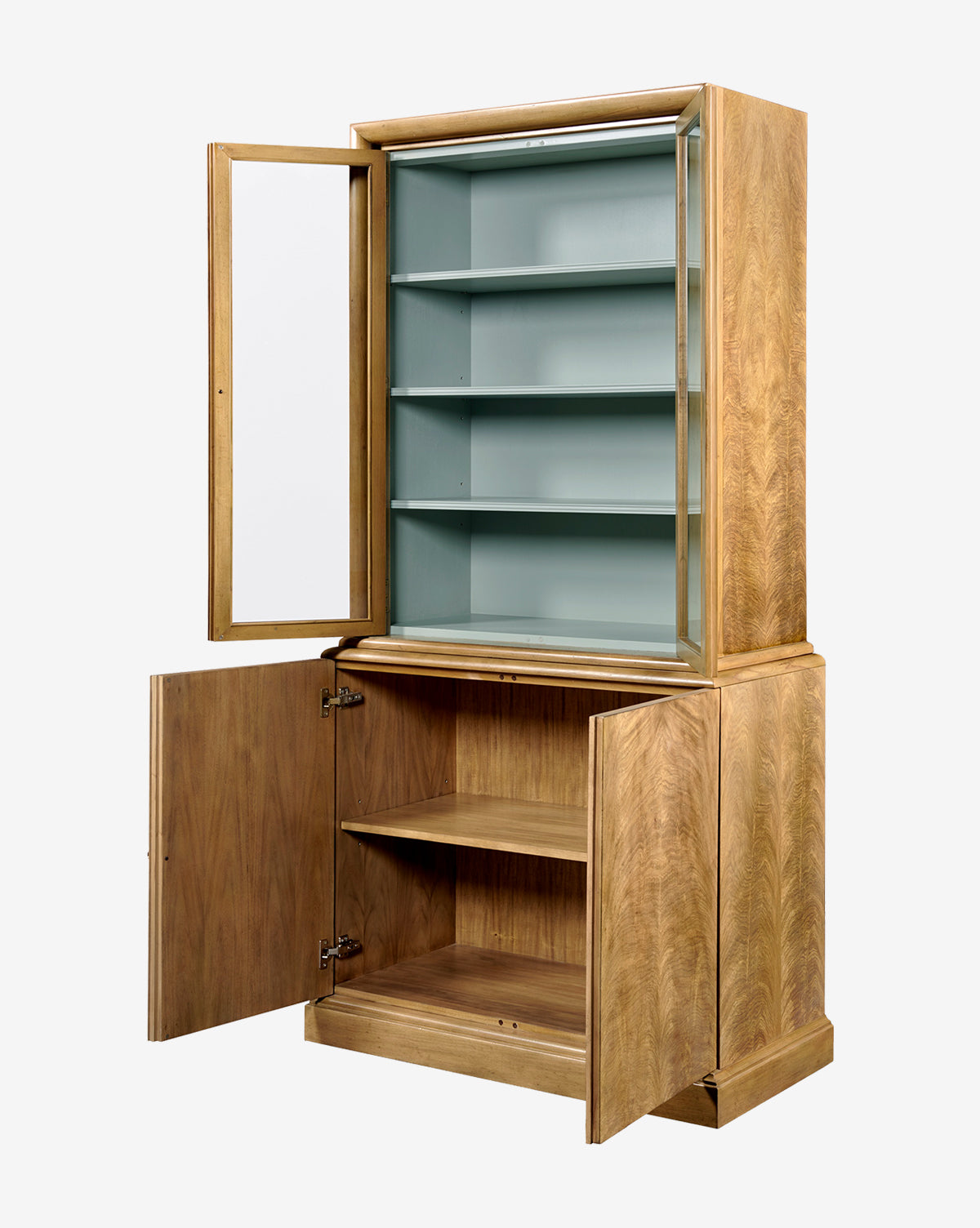 The Gethin Cabinet is a modern piece with two glass doors above three shelves and two solid doors below a single shelf, all open. The upper interior is painted light blue, by McGee & Co.