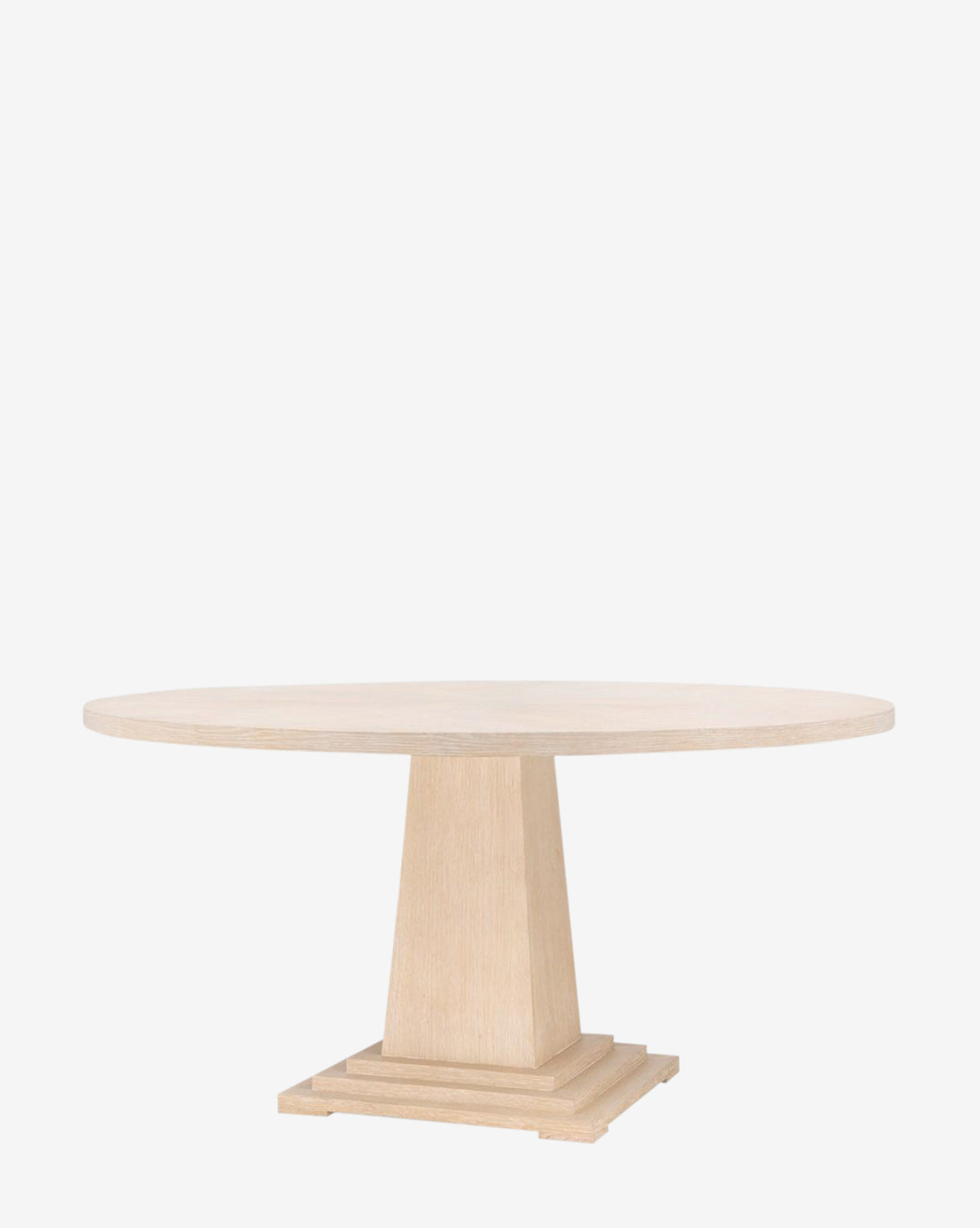 The Gideon Dining Table features a round light oak top, thick pedestal base, and stepped square platform, displayed against a plain white background by McGee & Co.