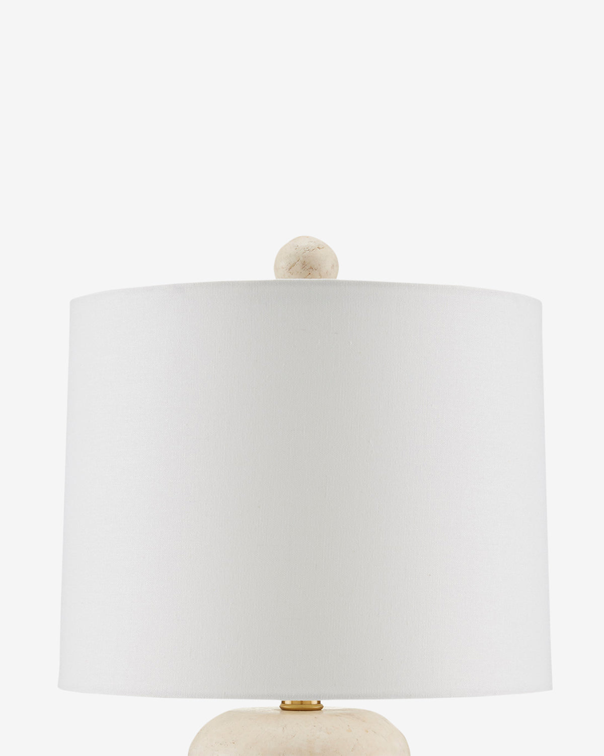 A close-up of the Girault Table Lamp featuring organic travertine texture, a round textured finial, and a smooth cylindrical shade, shown against a plain white background by McGee & Co.