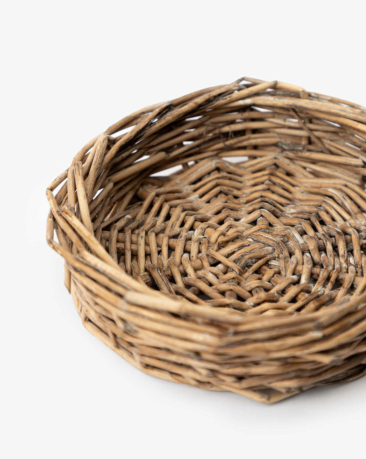 A close-up of the Glass Cloche with Woven Base, featuring an empty, round wicker base and intricate woven details, perfect for showcasing decorative items against a white background, by McGee & Co.
